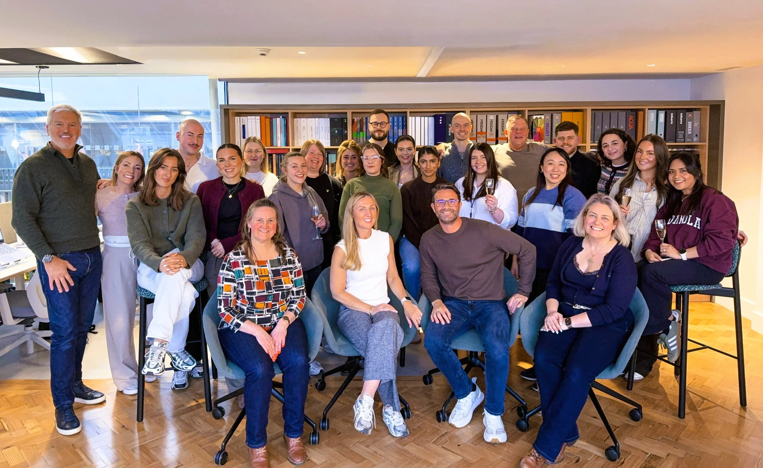 A group photo of the SpaceInvader team inside their new interior design studio at Sevendale House, Northern Quarter, Manchester.