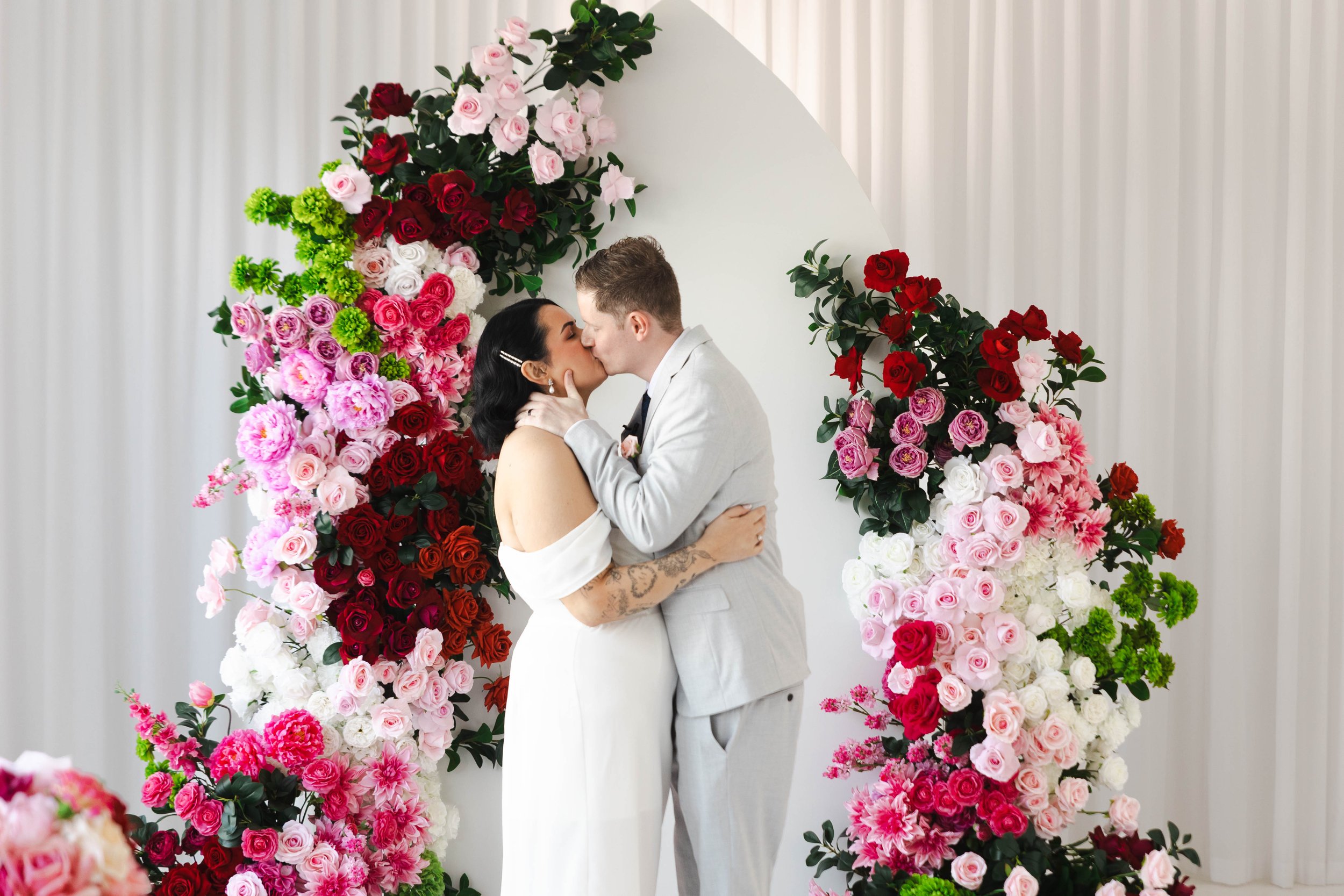 Shannon & Jarred's wedding at Faithwood Chapel – first kiss under the floral arch