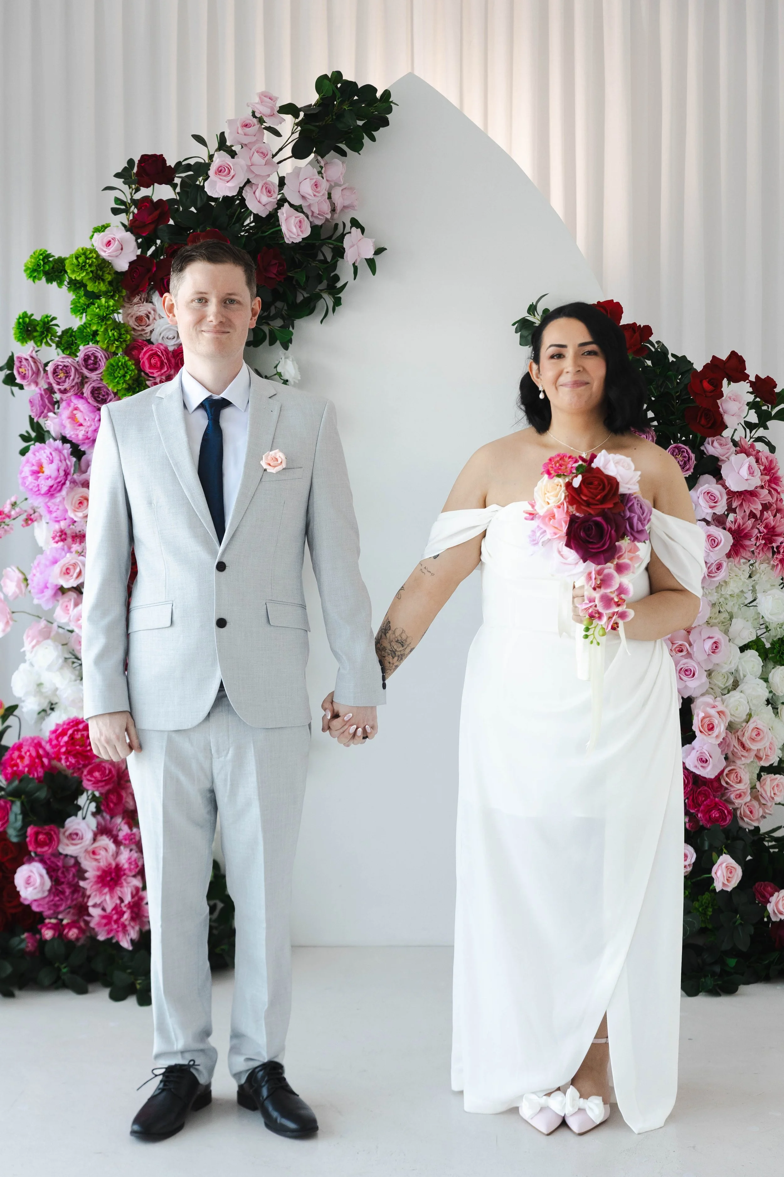 Shannon & Jarred's wedding at Faithwood Chapel – couple hand in hand surrounded by flowers