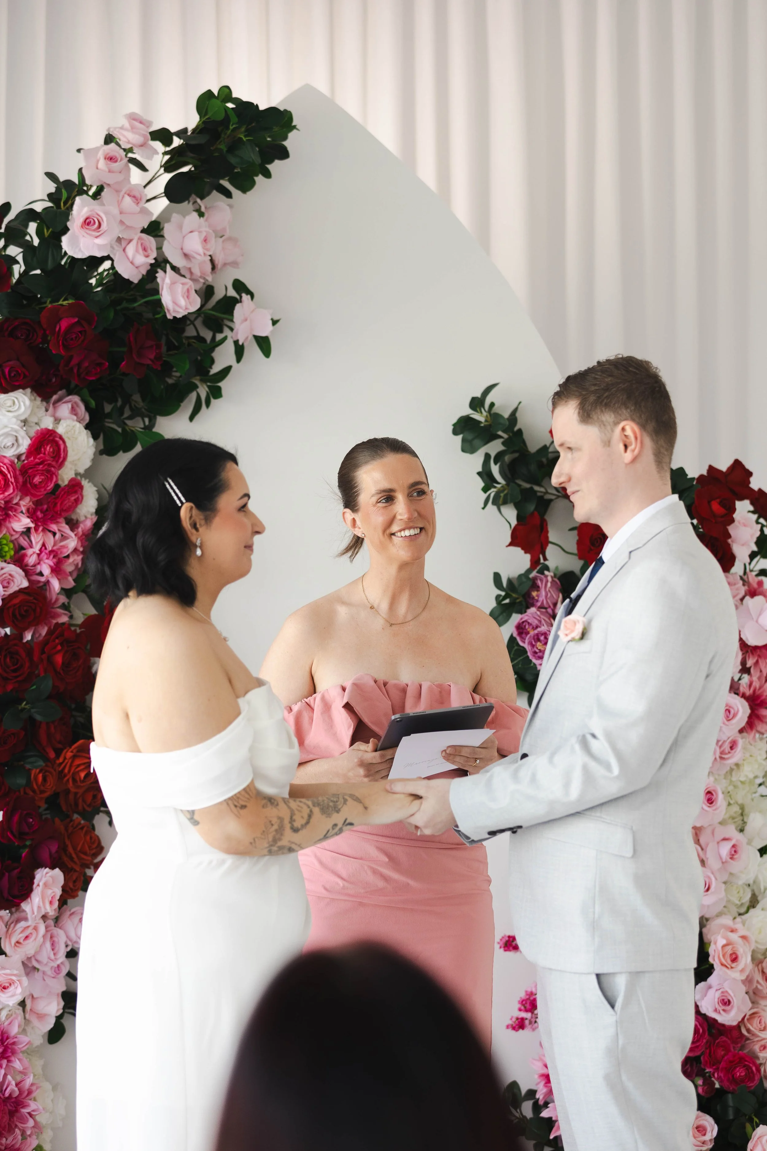 Shannon & Jarred's wedding at Faithwood Chapel – celebrant reading vows beside the couple