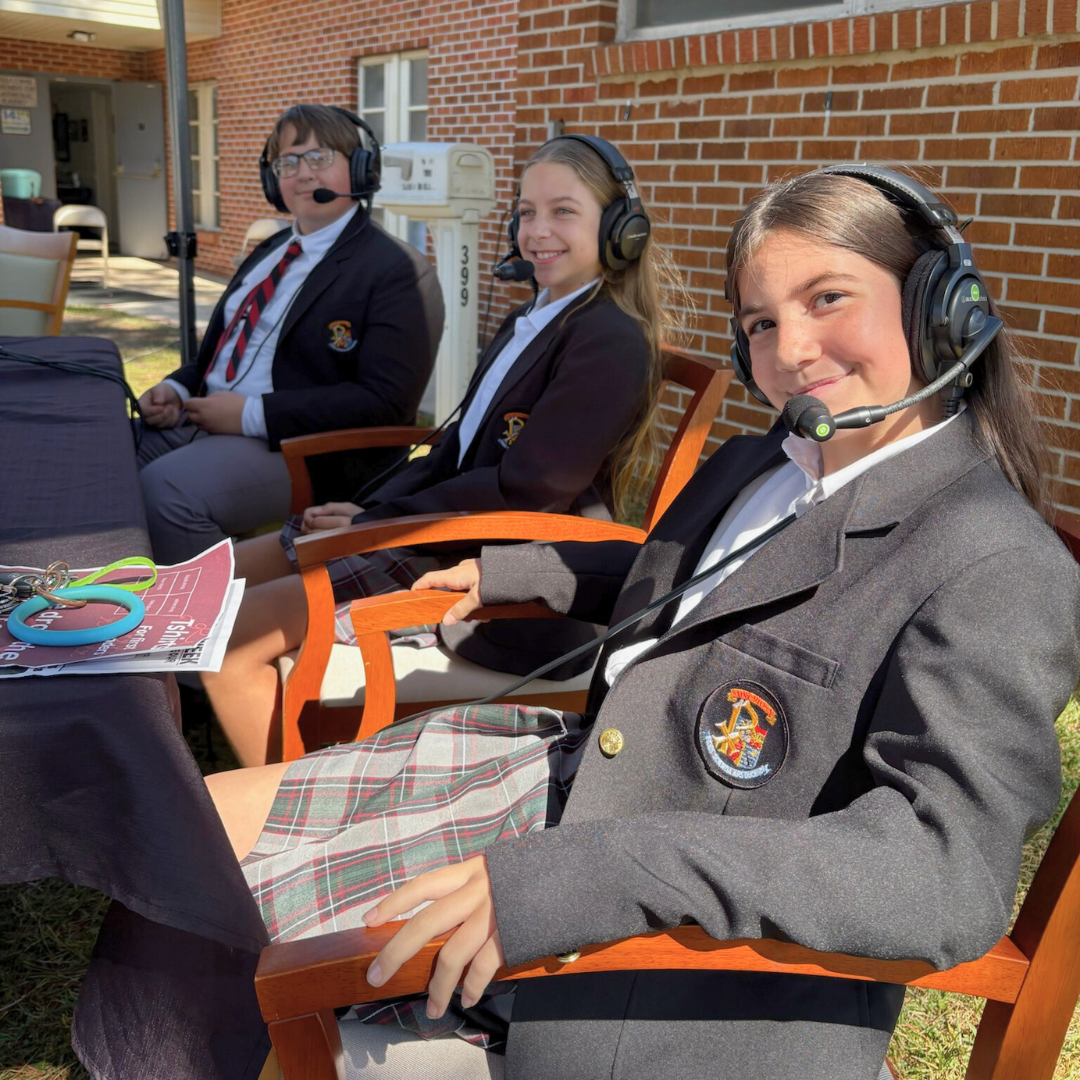 Students broadcasting with headsets at St. Pius X