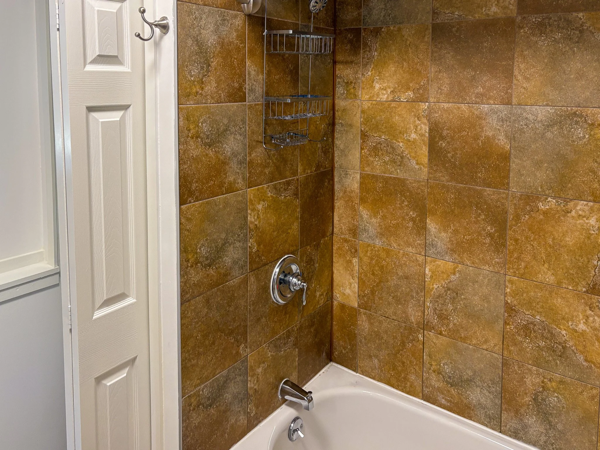 bathroom-tub-shower-stone-tile-surround.jpg