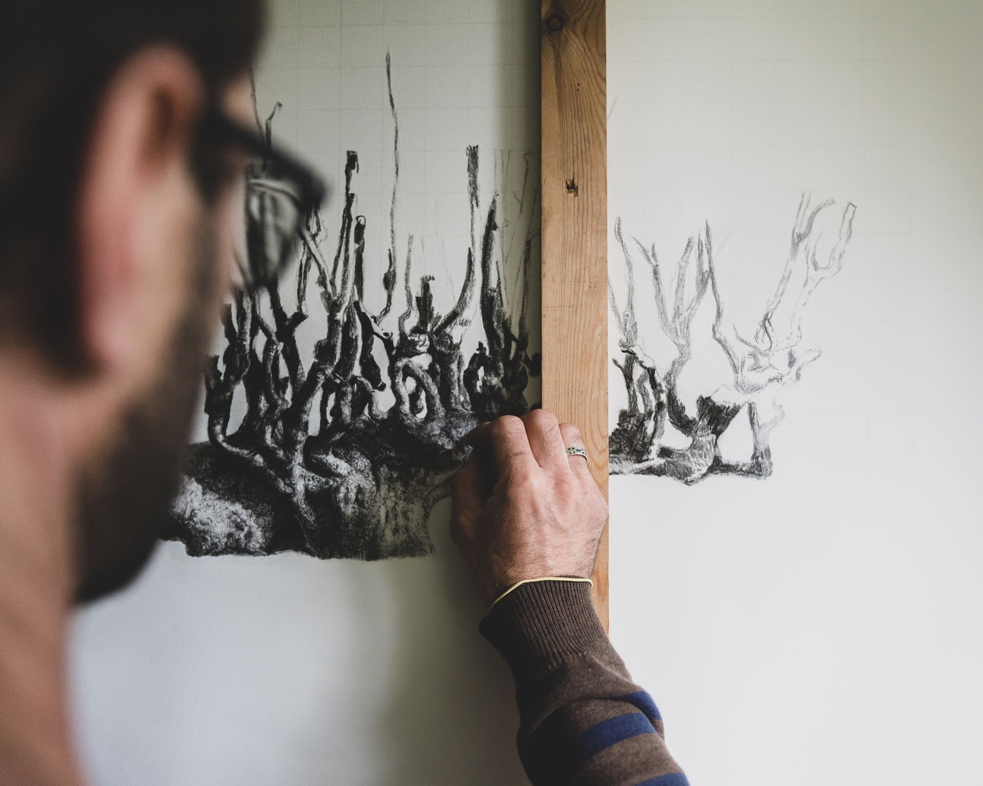 artist drawing tree with charcoal