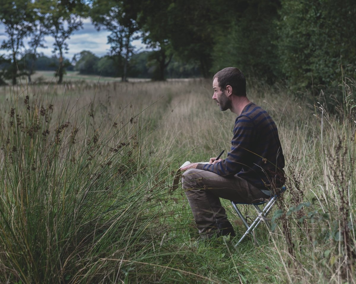 Artist sketching in a field