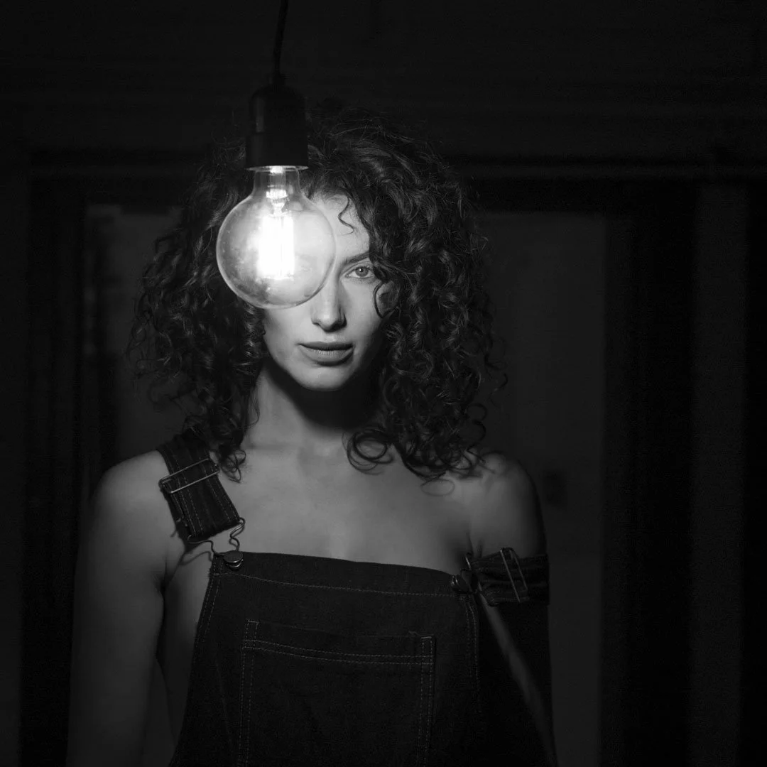 woman lightbulb dungeree