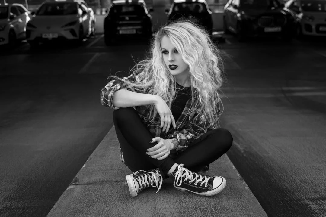 woman sitting car park