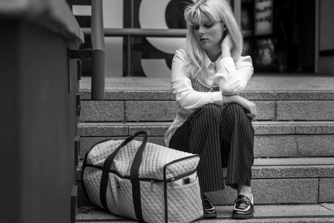 woman sitting holdall