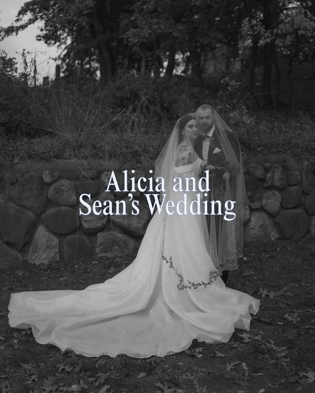 Black and white photo of a bride and groom standing together outdoors in front of a stone wall, with trees in the background. The bride is in a long wedding dress with a veil, and the groom is in a tuxedo. The text on the photo reads "Alicia and Sean's Wedding."