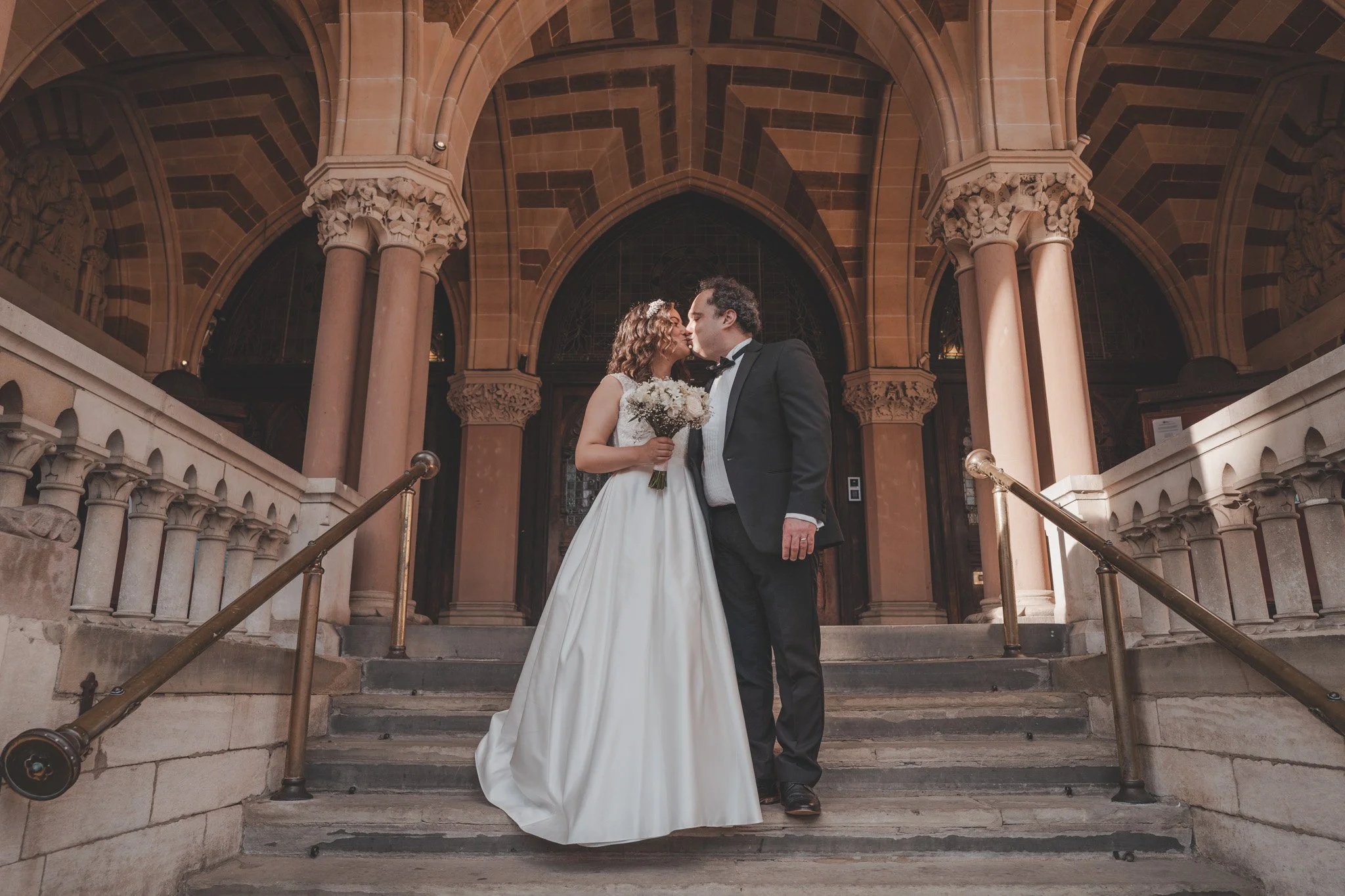 Bride and groom sharing a kiss after their civil ceremony at The Guildhall in Northampton