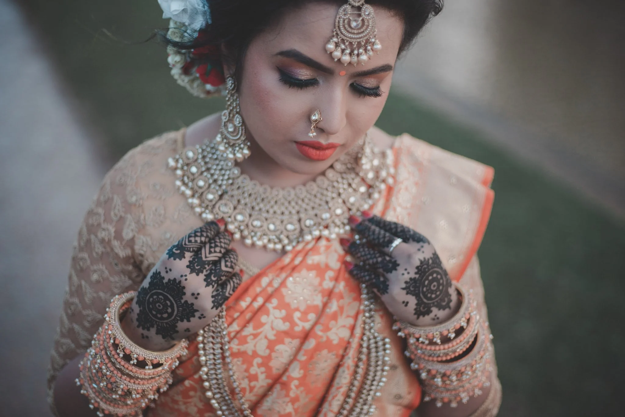 Details of jewelry and henna on a bride
