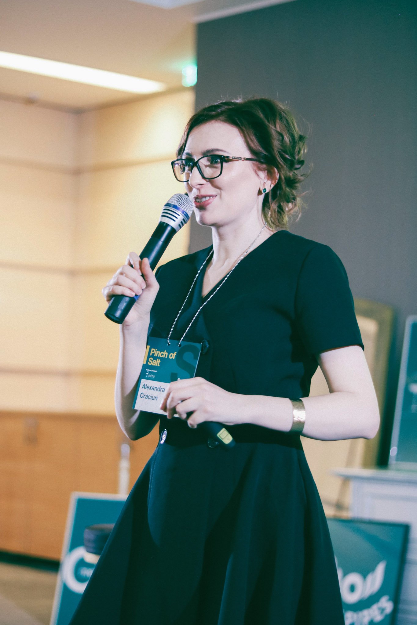 Woman talking on a stage at a Conference in Romania