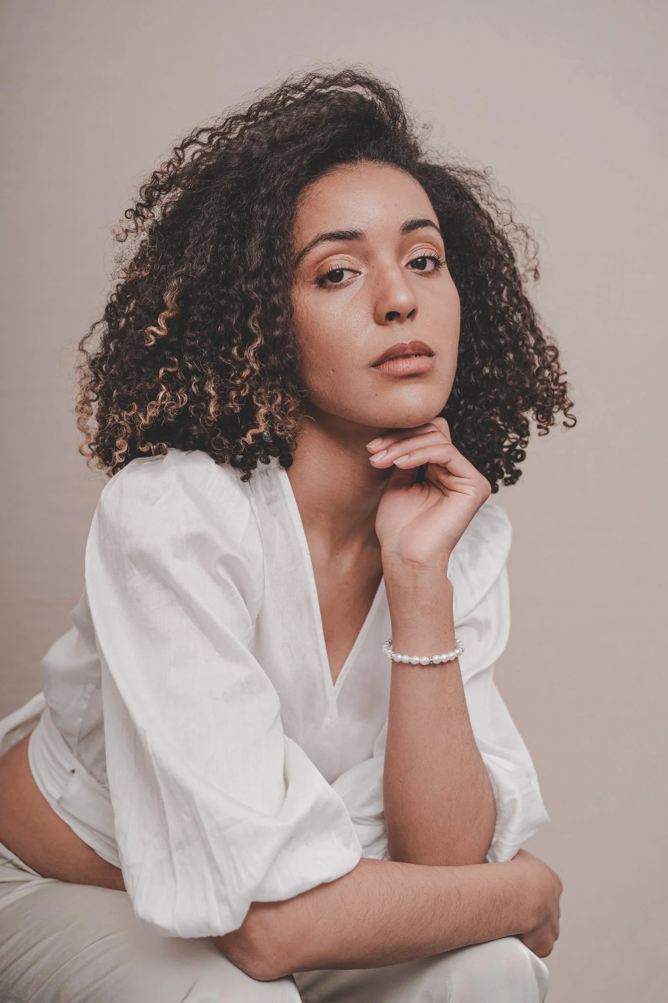 Girl wearing white looking at the camera at a studio portrait session in Coventry