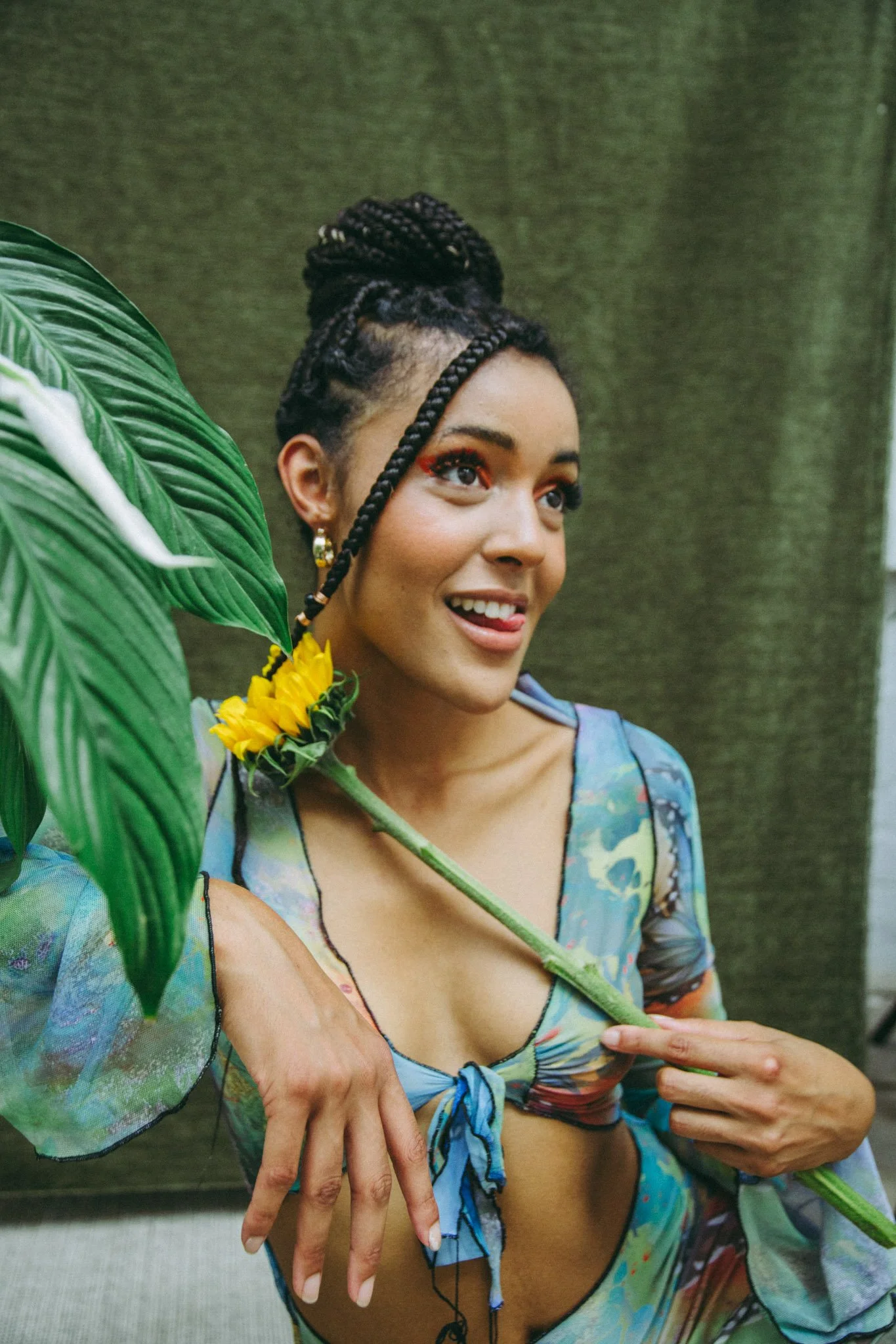UK musician Danniella Dee holding a flower and smiling in a studio photography session in Birmingham