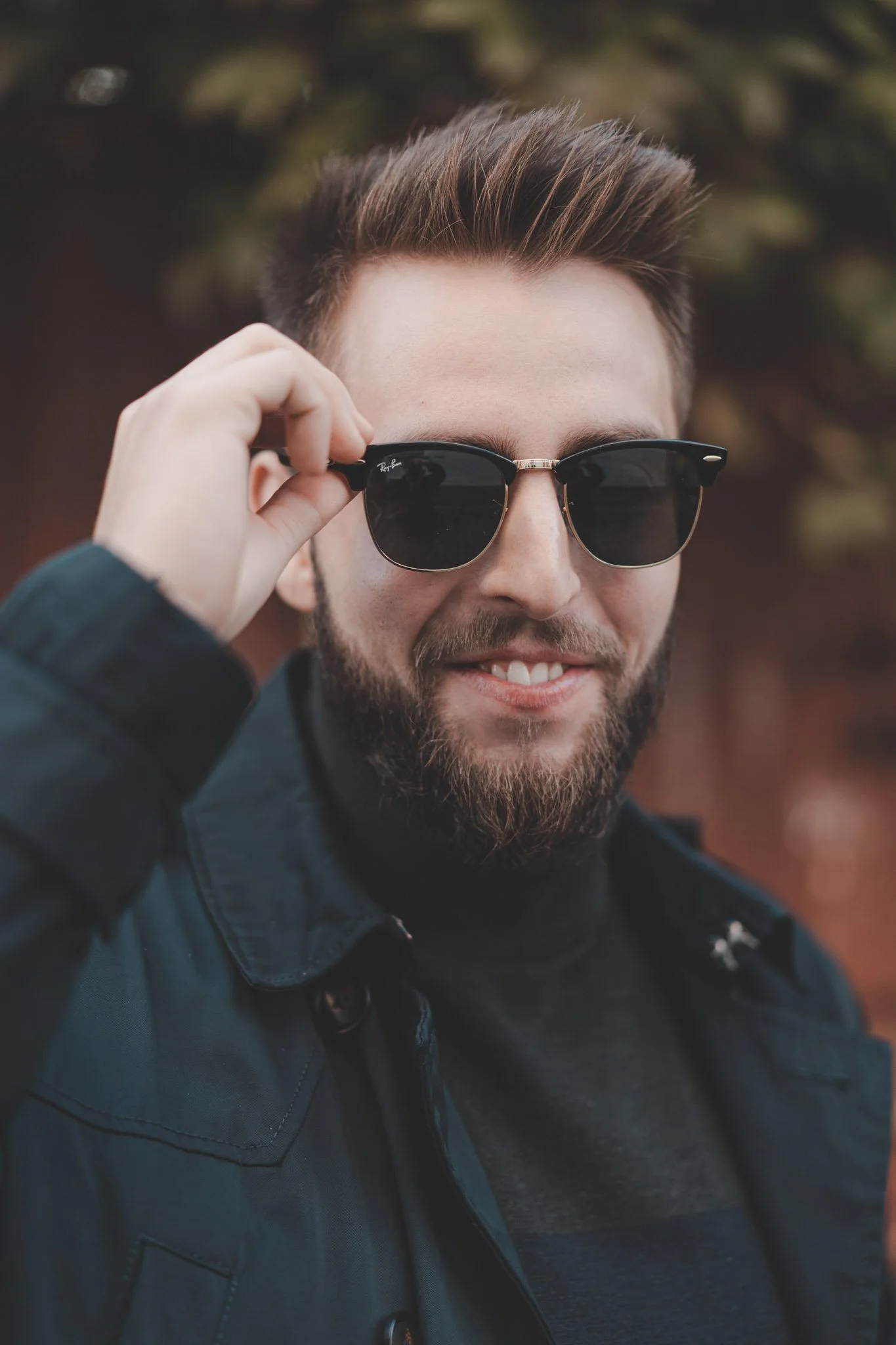 Young guy with sunglasses on smiling at the camera