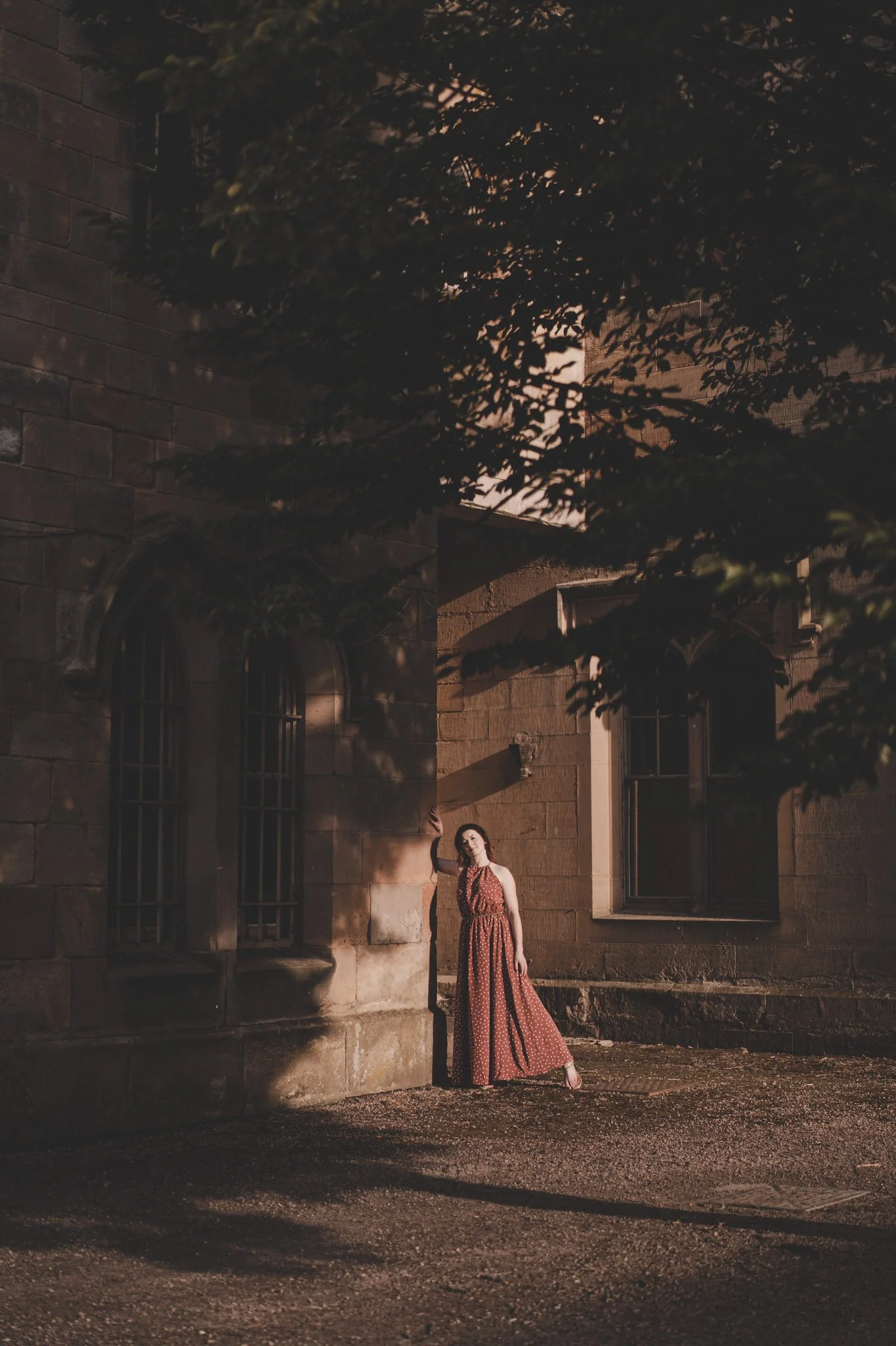 Woman wearing a red dress standing in the sun light