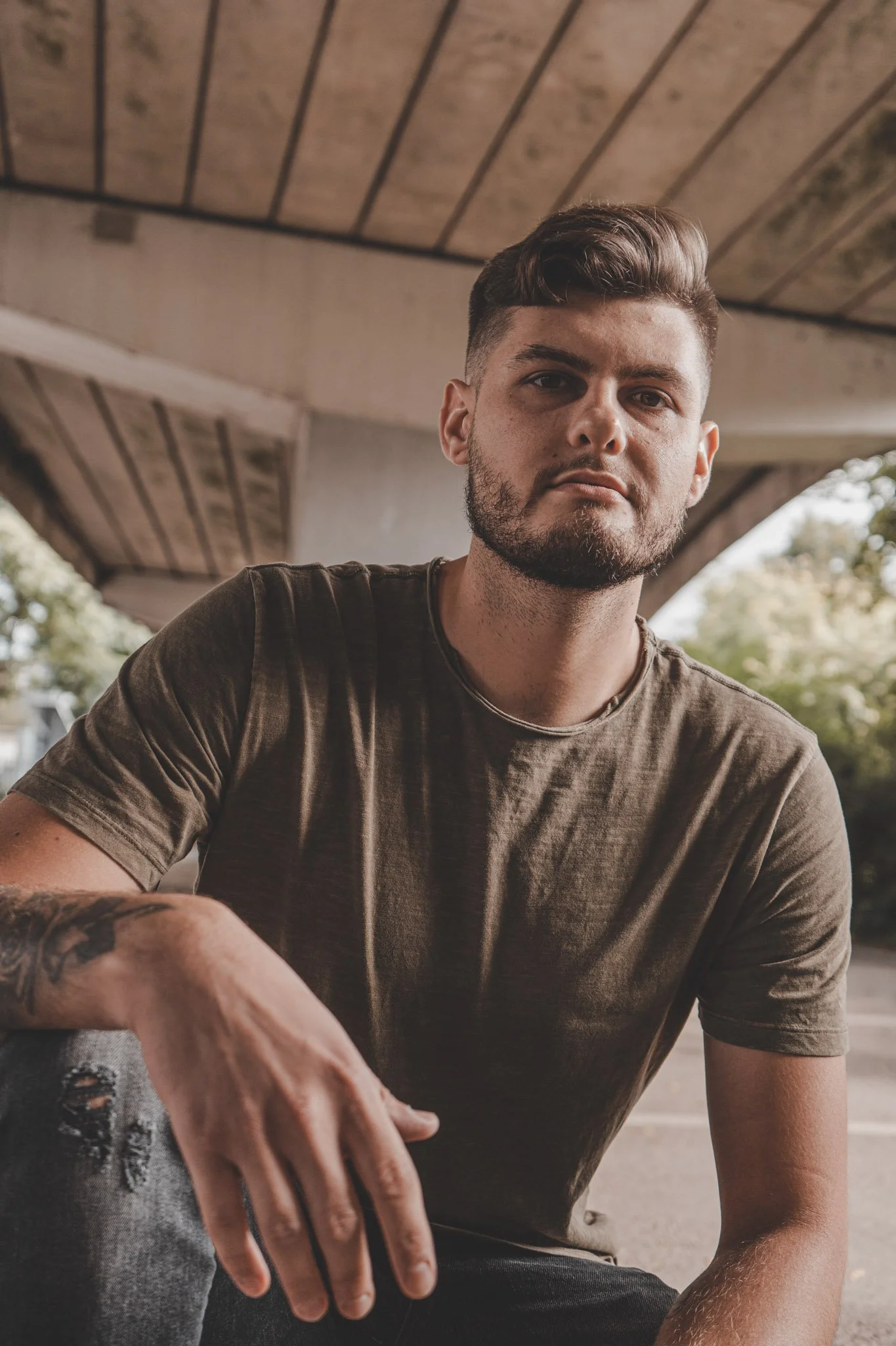 Young man posing for the camera under a bridge in Coventry