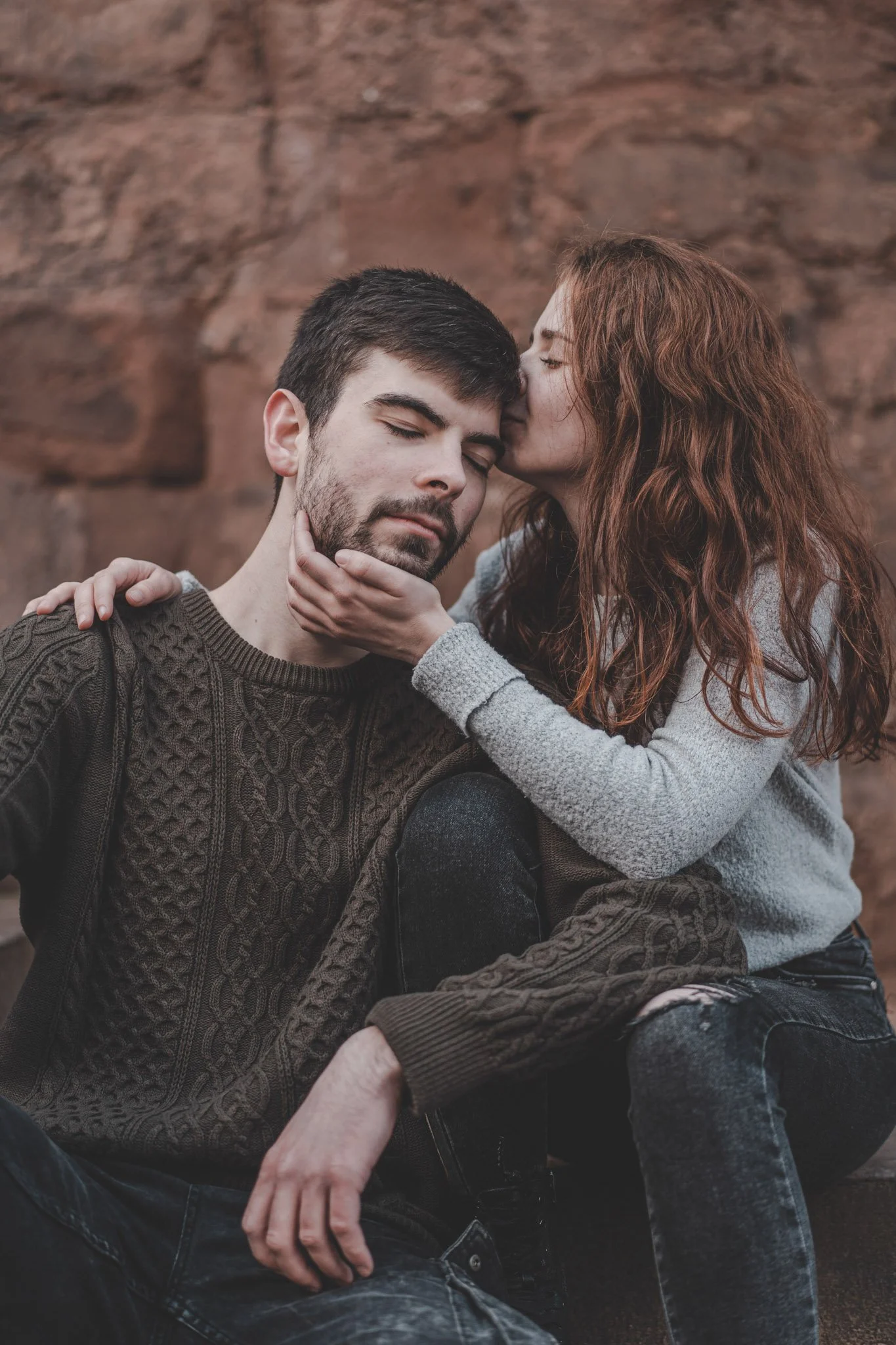 Girl holding her boyfriend in her arms, kissing his forehead in Coventry