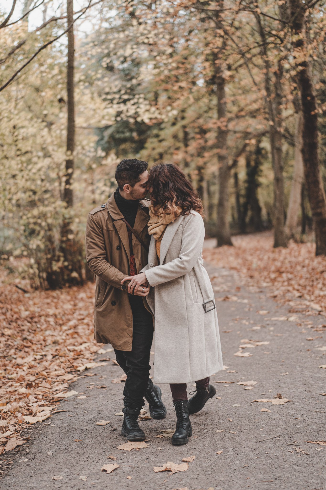 Couple kissing on a Coombe Abbey Park  path, in Coventry