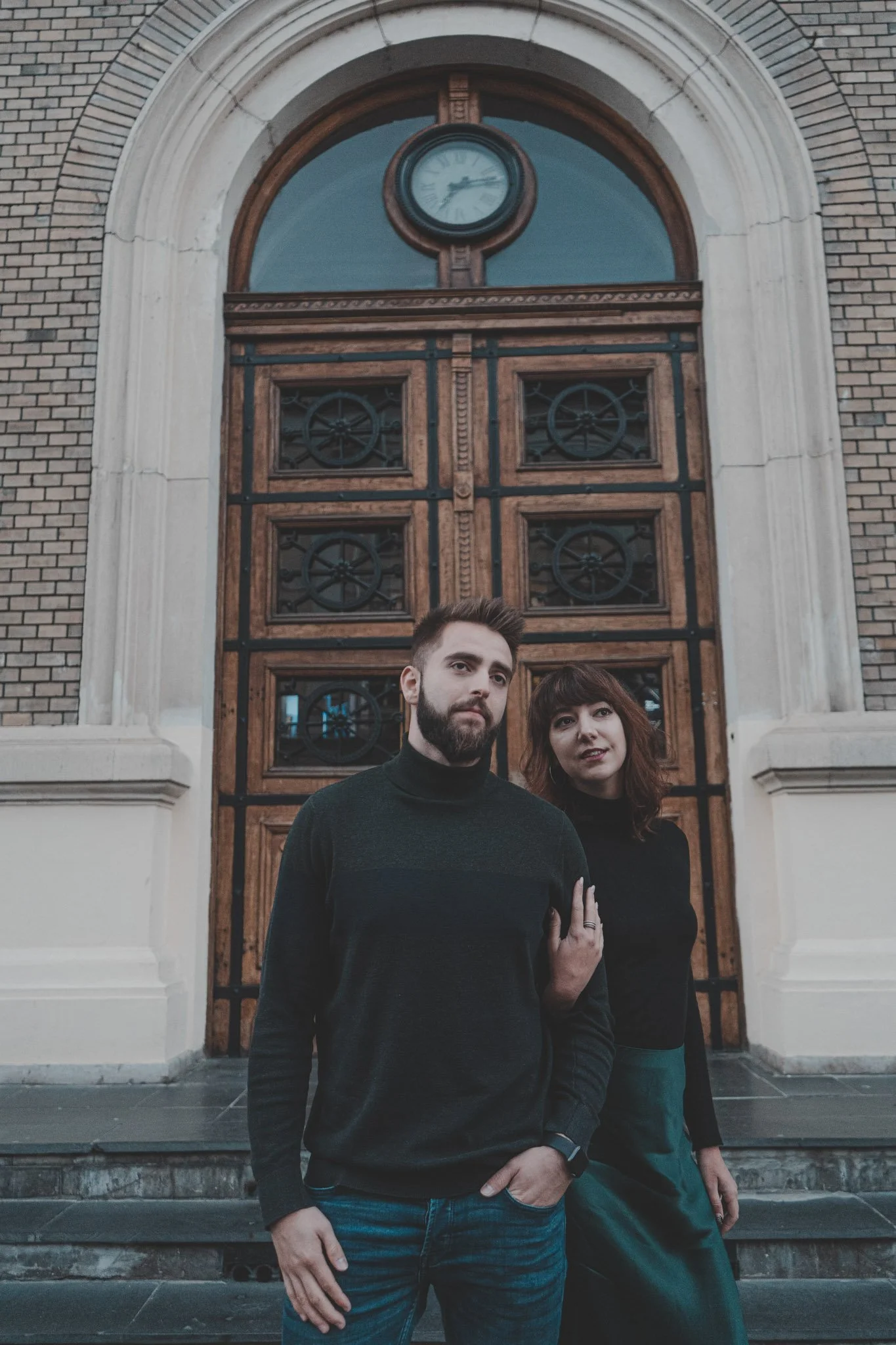 Boyfriend and girlfriend photographed in front of the main gate of Babeș-Bolyai University, Cluj-Napoca
