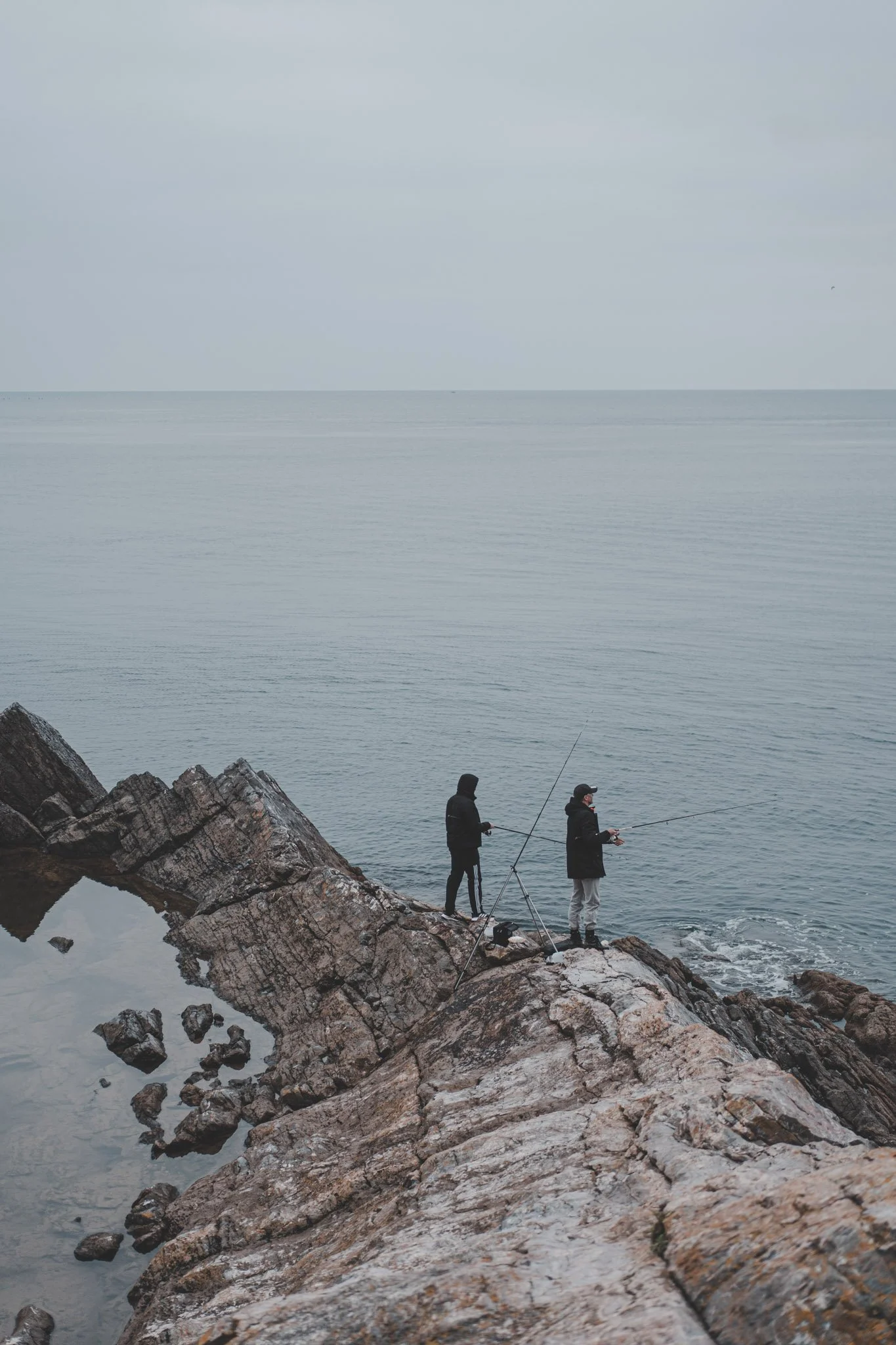 Two fisherman photographed from a distance in Cornwall