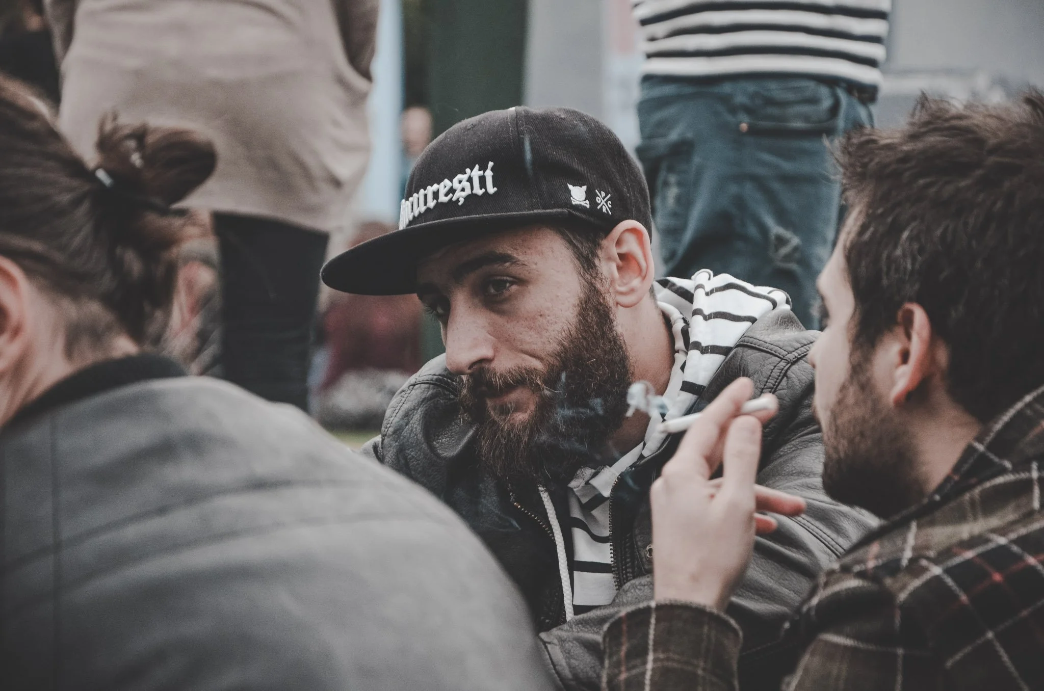 Portrait of a man sitting with a group of friends at a jazz festival in Cluj-Napoca