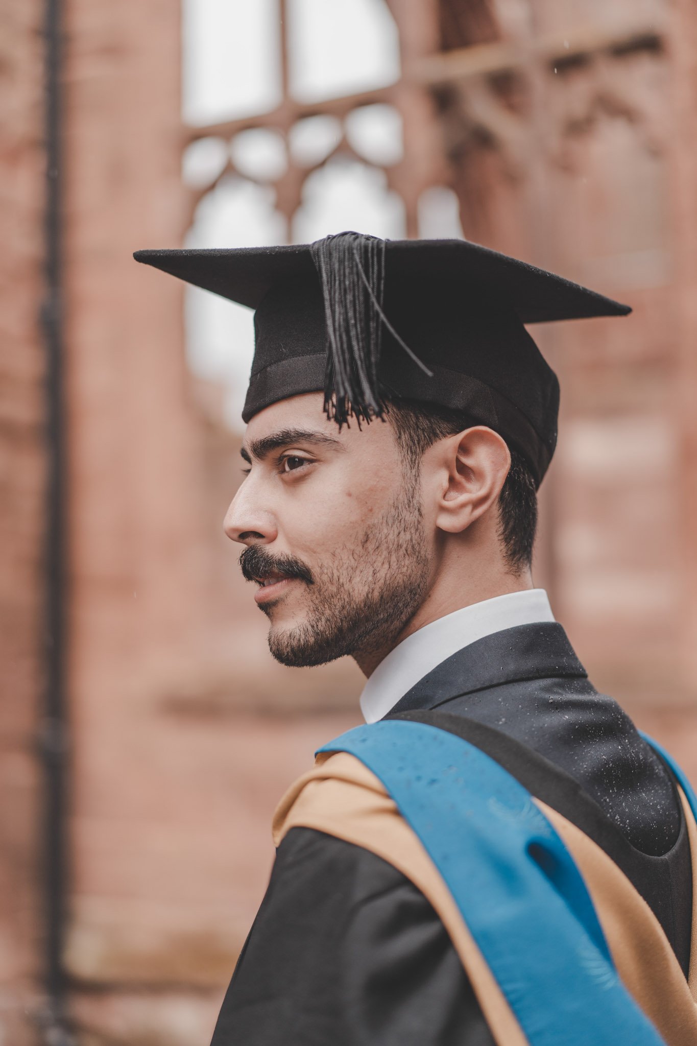 Side portrait of a young man on his graduation day in Coventry city centre