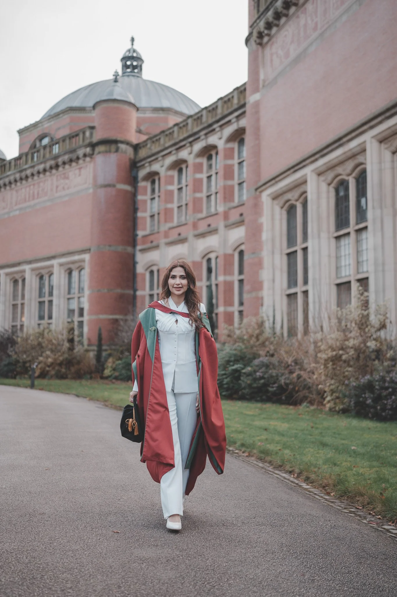 Girl walking through Birmingham University on graduation day