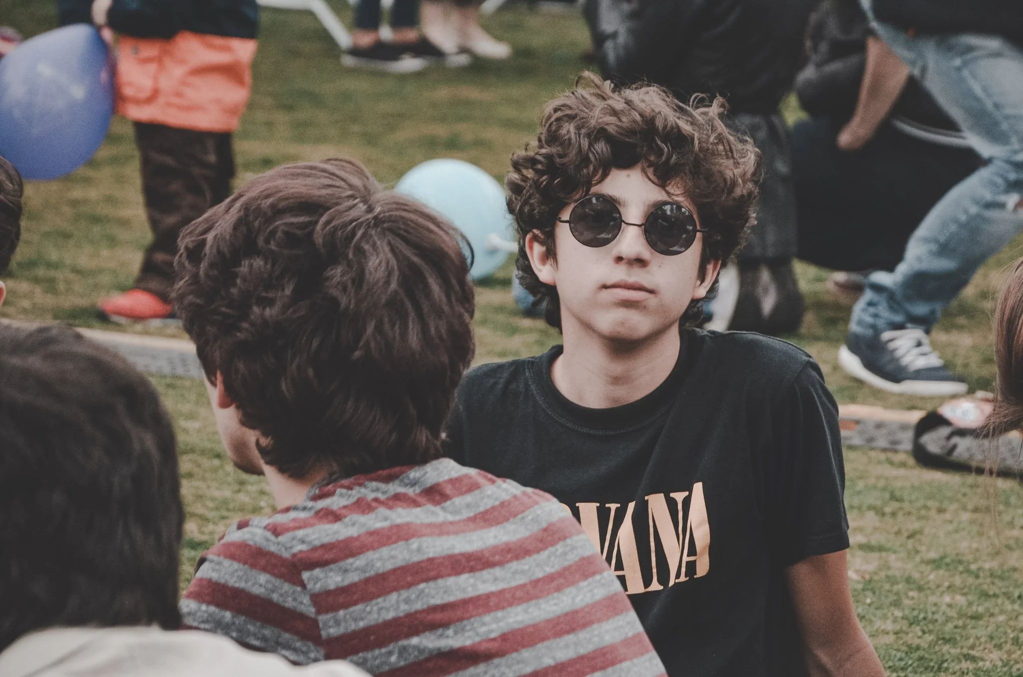 Boy wearing sunglasses at a festival in Romania