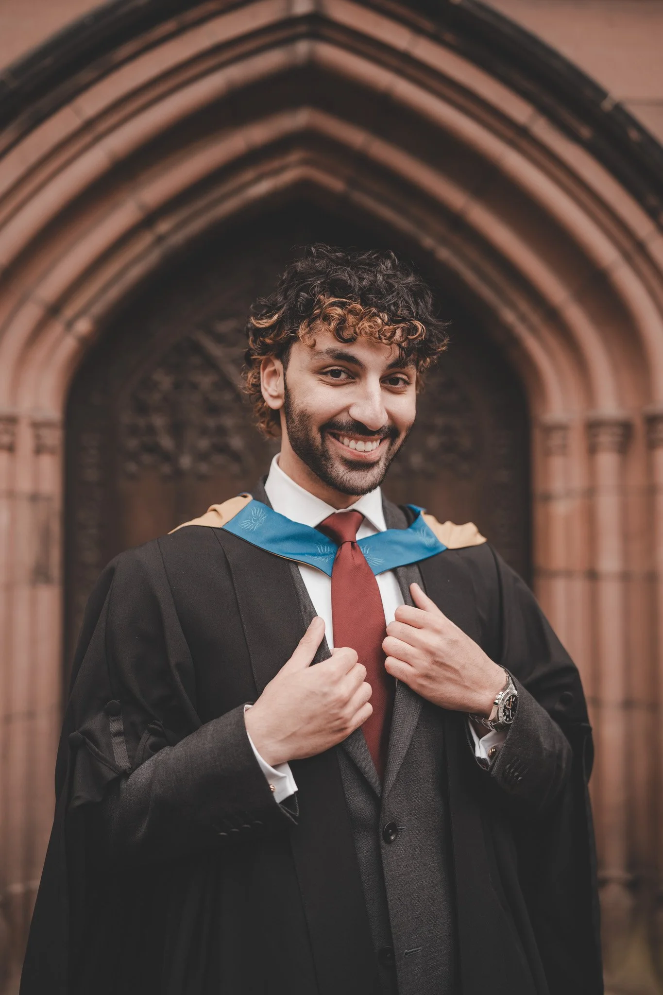 Boy smiling at the camera during a graduation photoshoot in Coventry