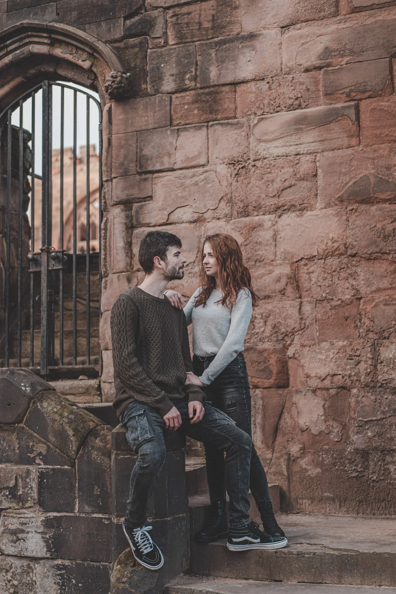 Young couple hanging together around Coventry Cathedral ruins