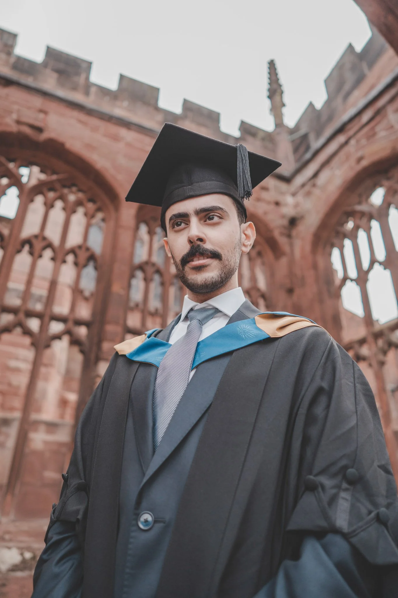 Portrait of a boy on his graduation day in Coventry Cathedral ruins