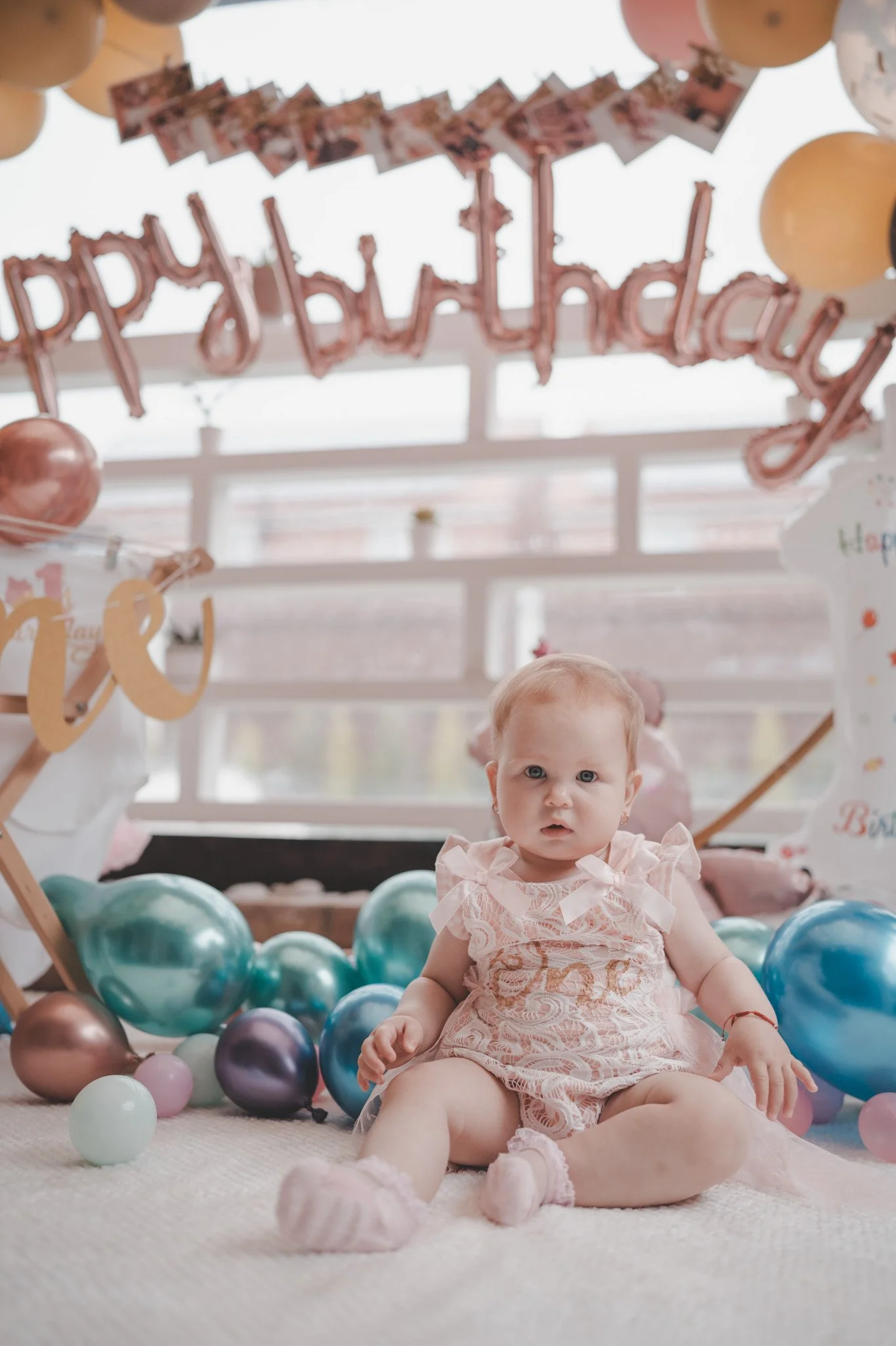 Portrait of a little girl wearing birthday dress in between birthday accessories 