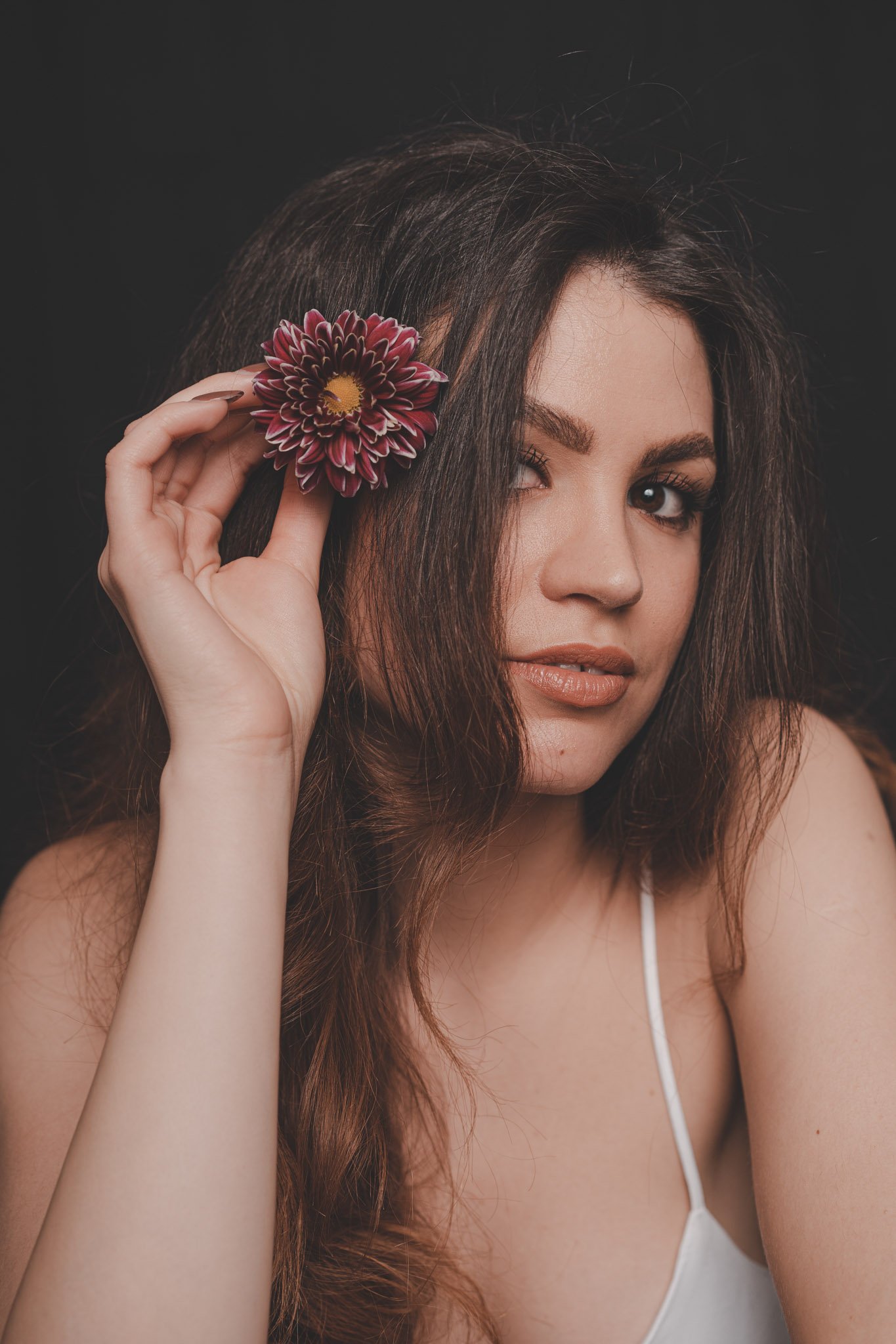Studio photography session of a young girl with flower