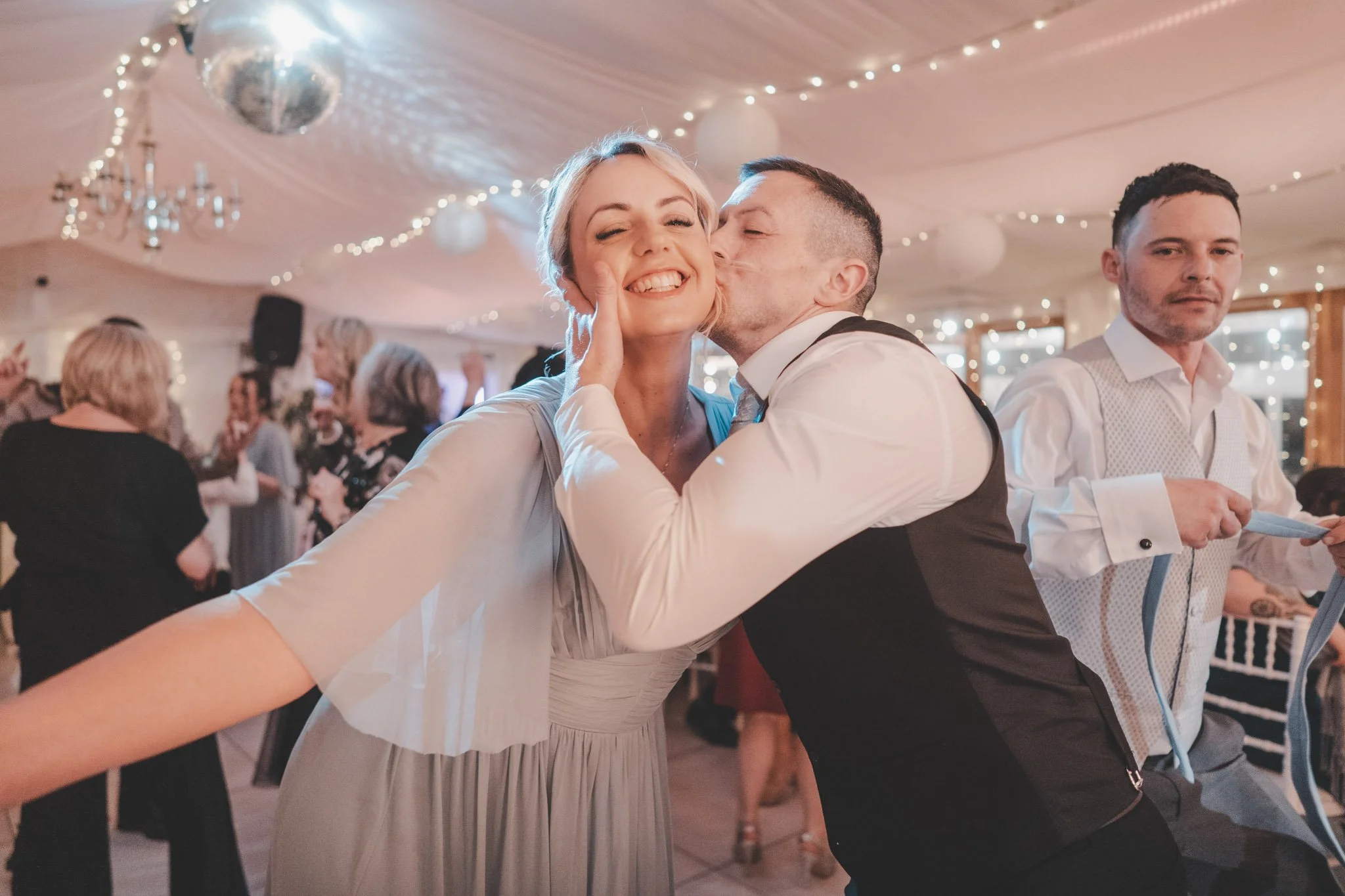 Man kissing girl on the cheek on the dance floor