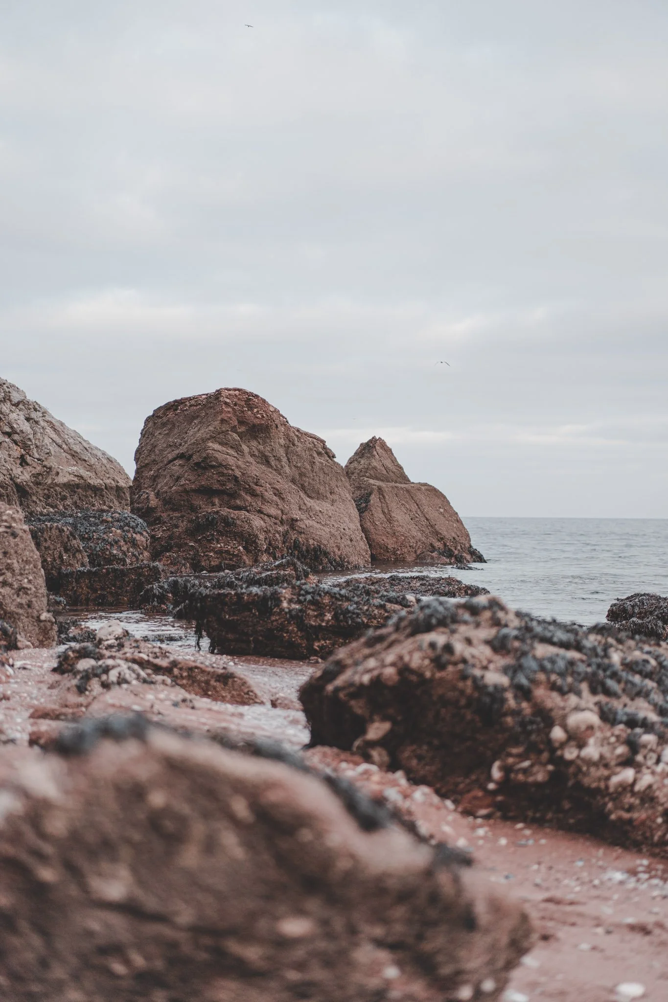 Vertical image of rocks and sea in Cornwall