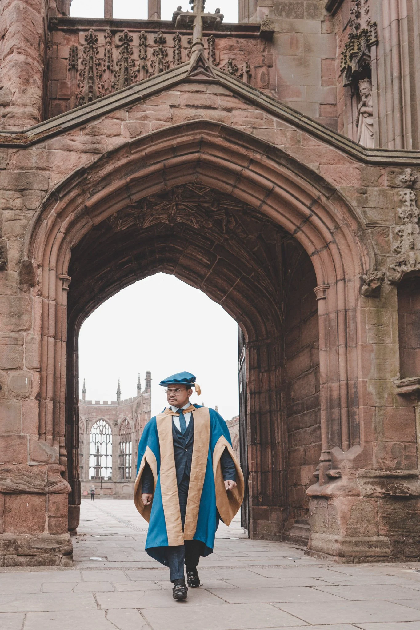 Guy walking towards the camera during his graduation day