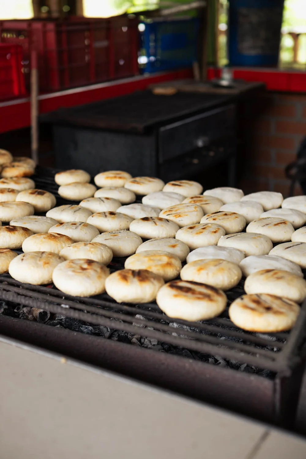 Bread toasting on a grill over charcoal