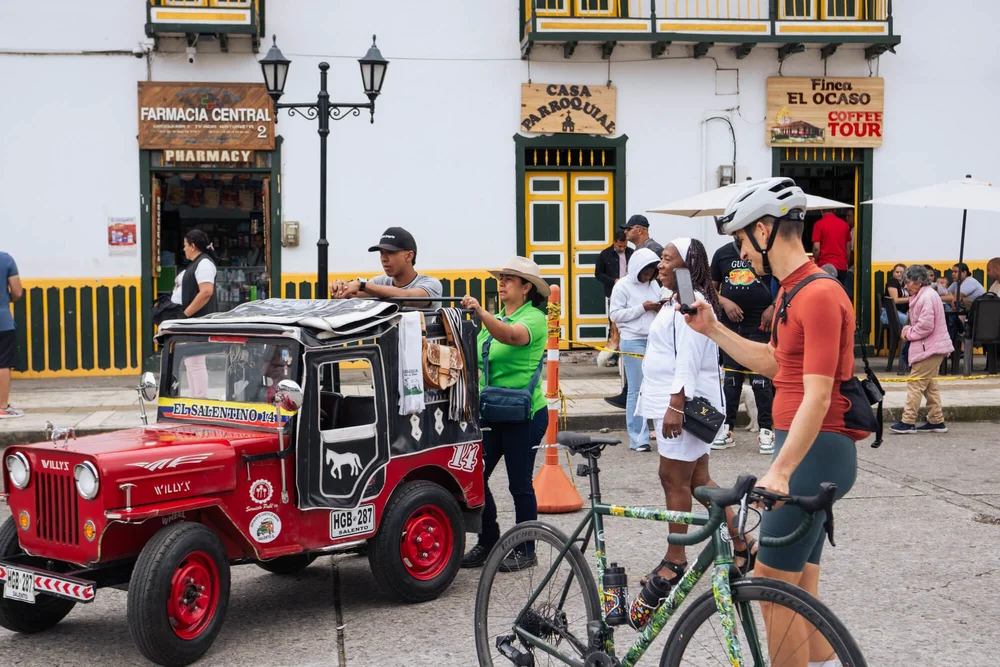 A colorful building with people and bicycles, Into Coffee Heartlands