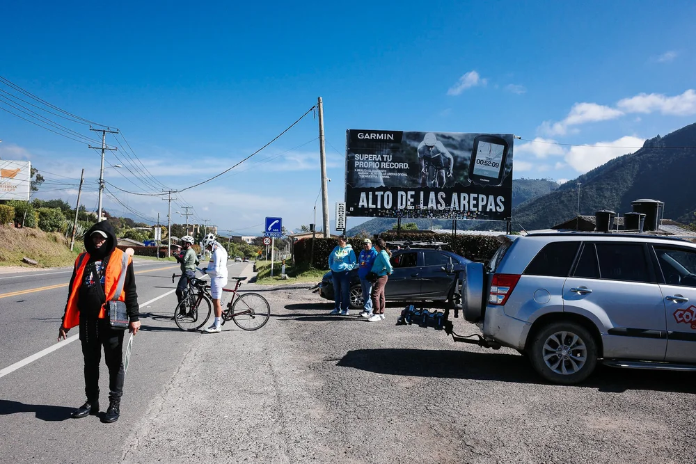 Cyclists by road sign