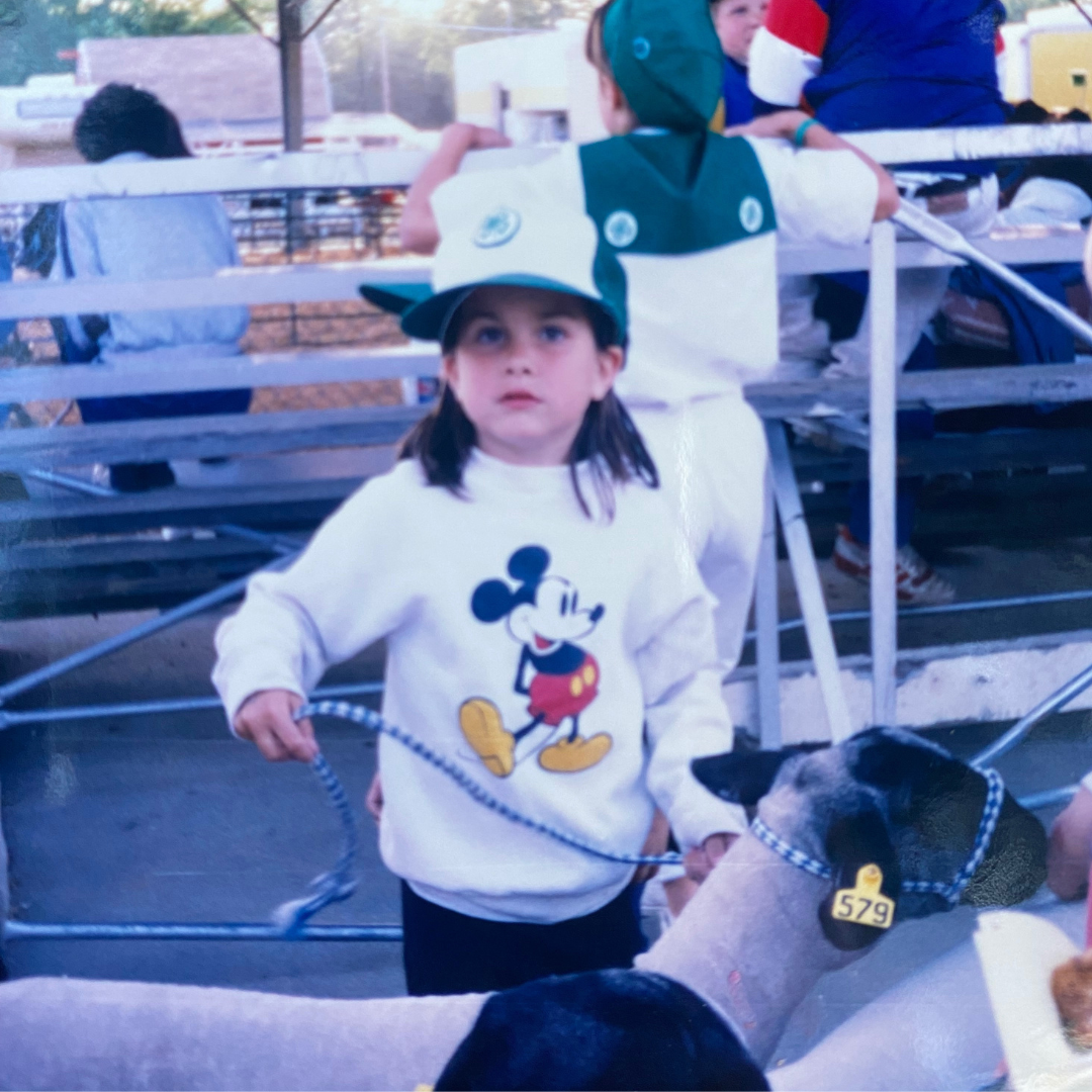 author Sarah, a highly sensitive child, with a sheep