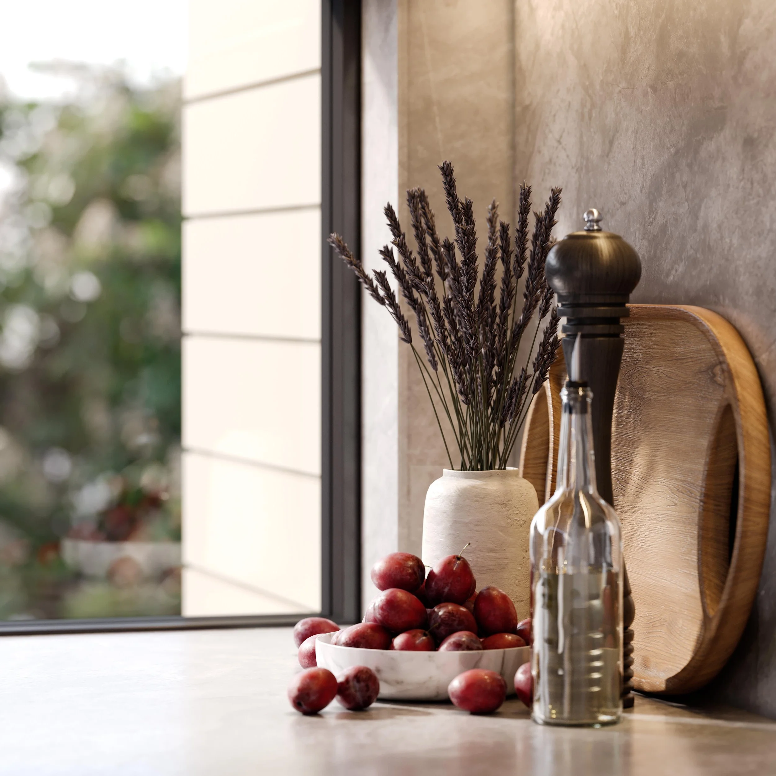 A bowl of red grapes on a kitchen counter with a glass container and a vase with dried flowers, near a wooden tray and a window in the background.