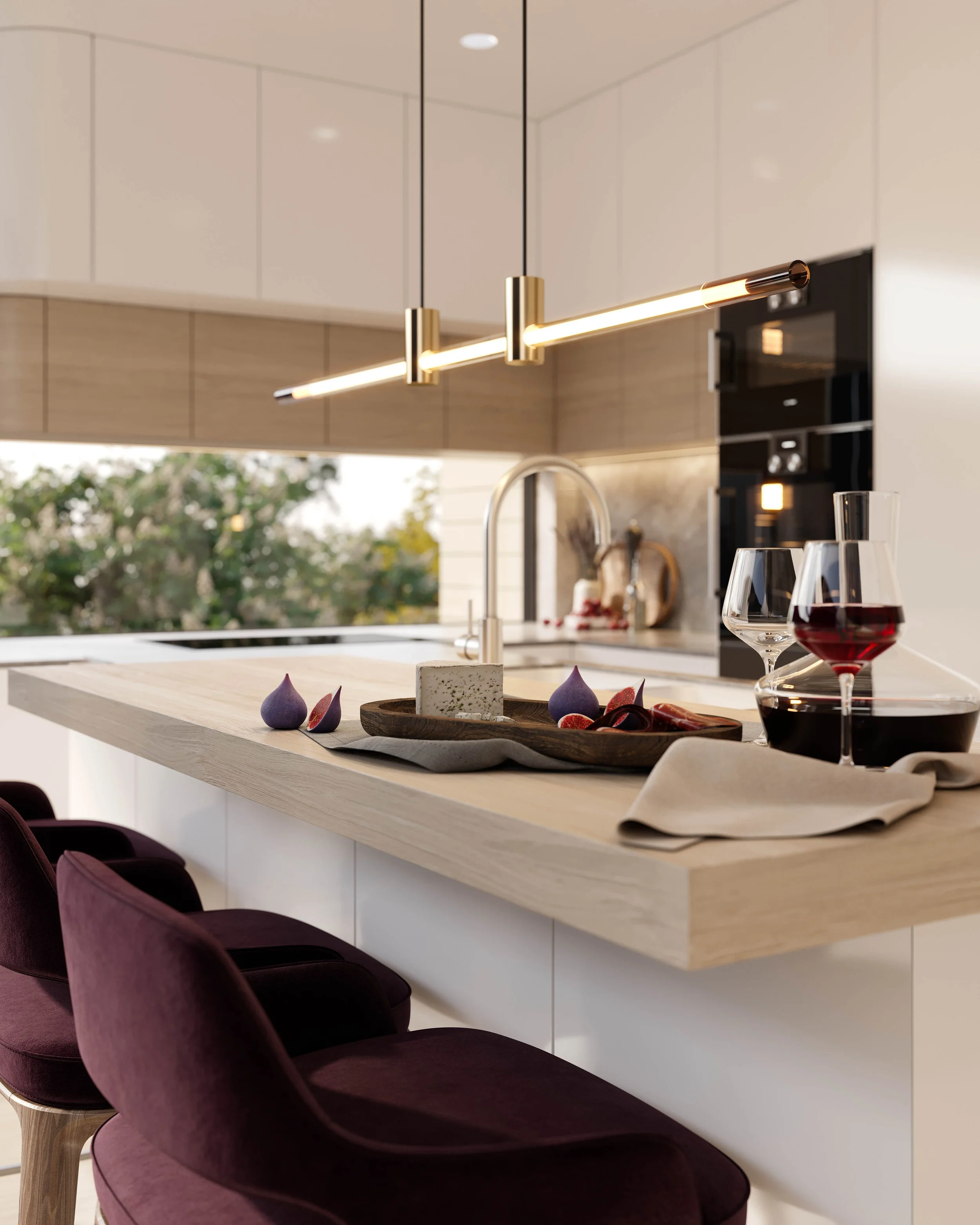 A modern kitchen island with a wooden surface, set with two glasses of red wine, a small wooden serving tray with cheese and figs, and a beige cloth. Above, there is a contemporary gold pendant light fixture. In the background, there is an oven and a
