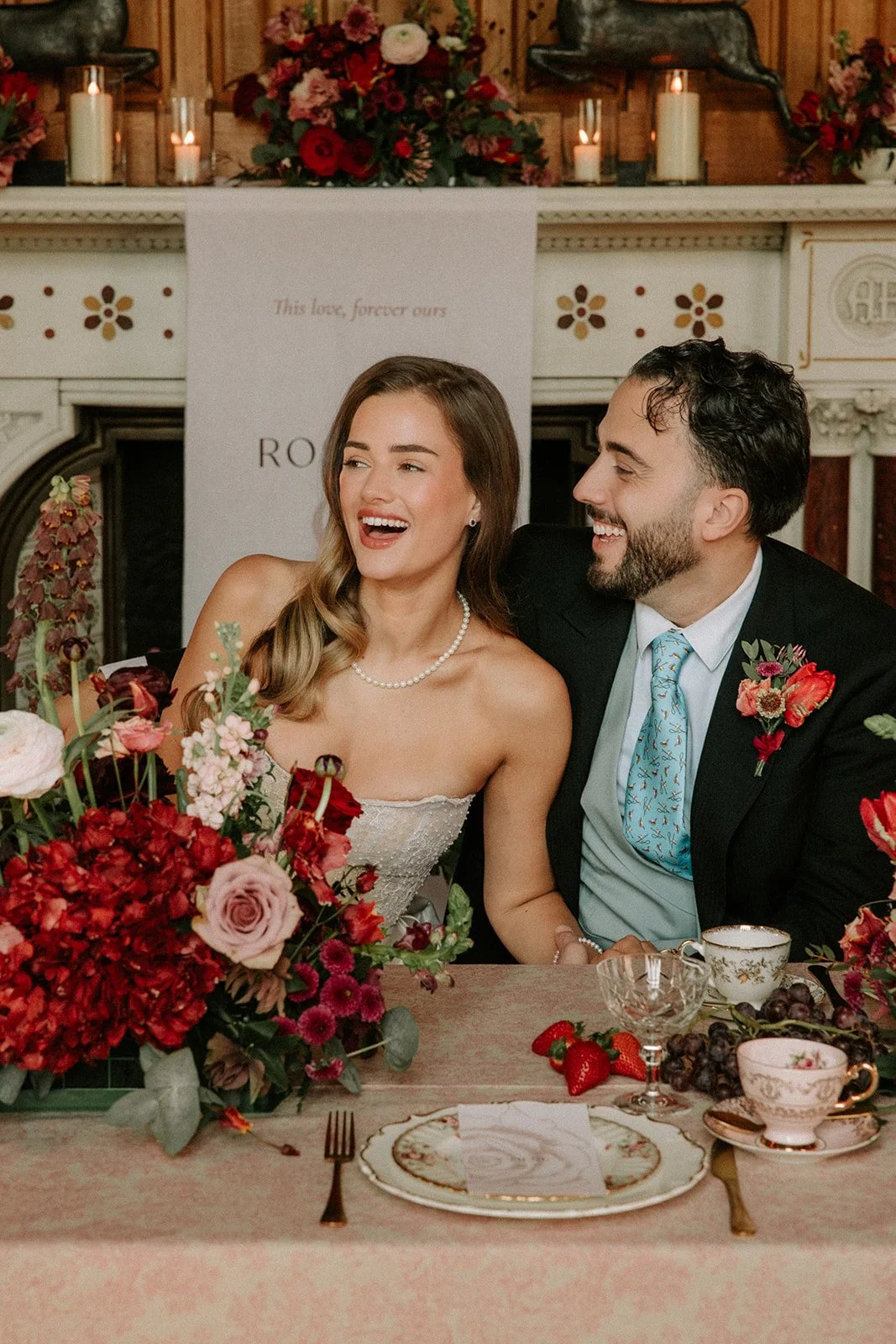 English-Rose-red-themed-wedding-breakfast-table-couple.jpg