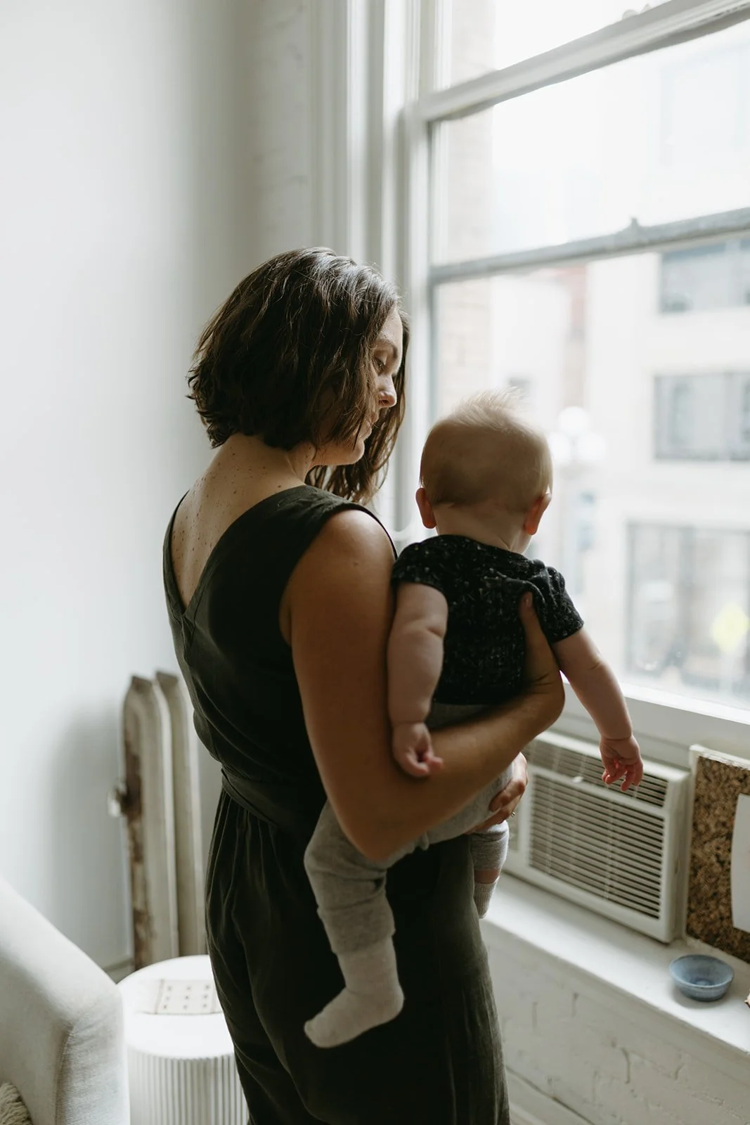 a mother and baby at the window