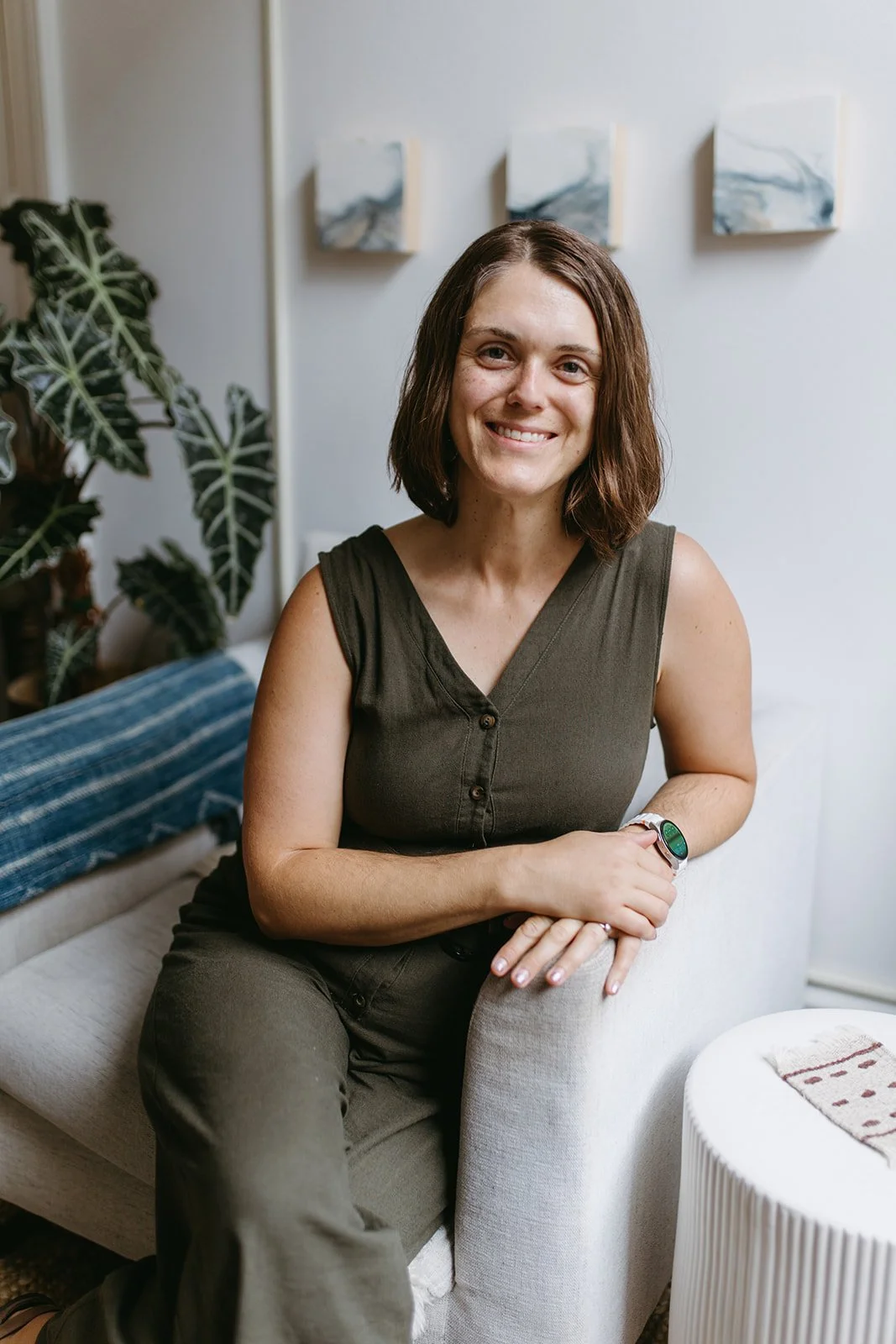 Michelle Jones, perinatal therapist, smiling in a bright, plant-filled room
