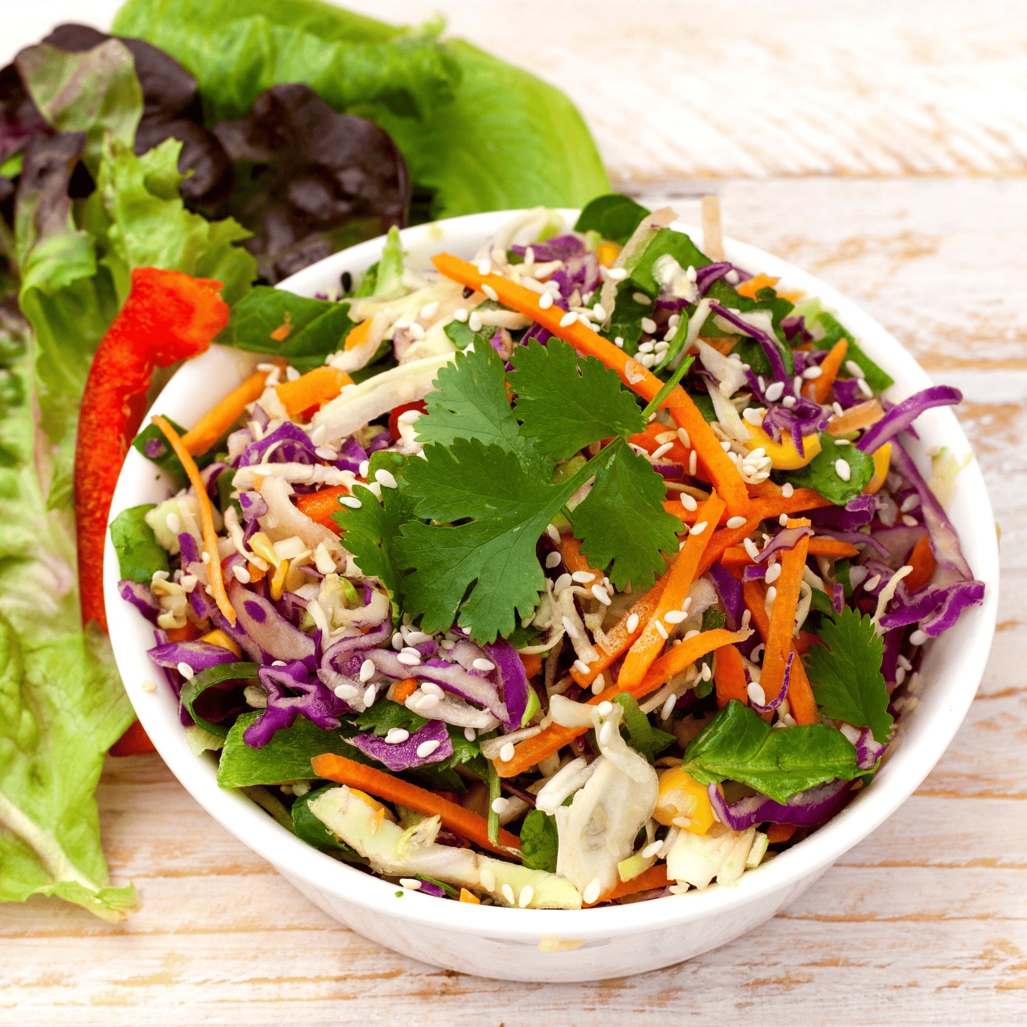 Photo d’un slaw croquant au chou rouge, carottes, pomme verte et œufs durs, servi avec une sauce au yaourt à l’aneth