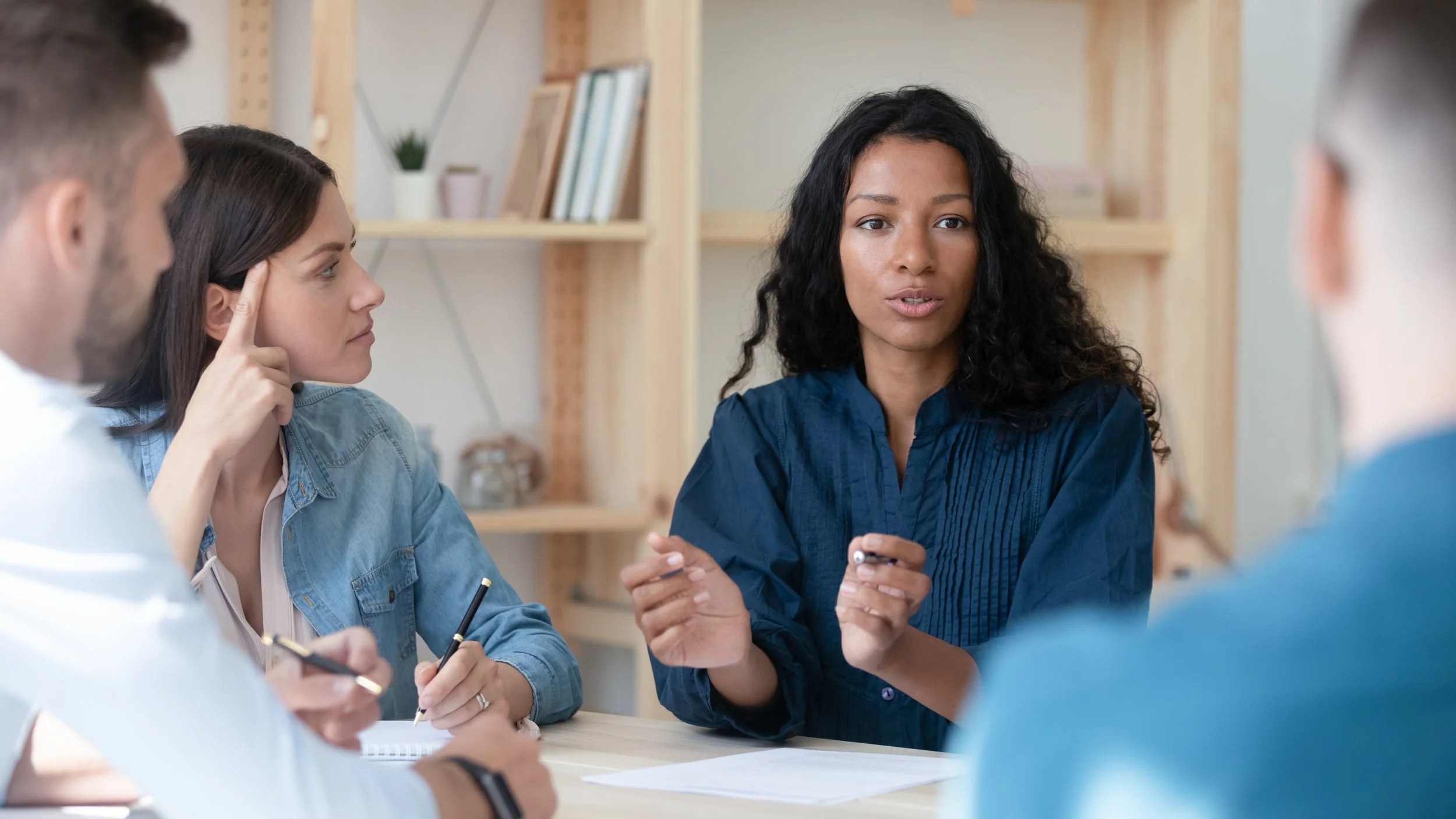 Four people talking at table