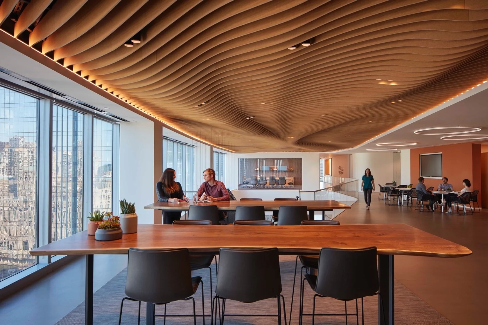 Architectural acoustic panels and ceiling baffles used to control sound reflections and reverberation in a modern workspace.
