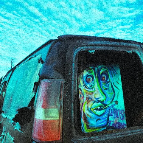 Deranged Deandre inside a burned van.