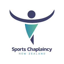 Logo for Sports Chaplaincy New Zealand, featuring a stylized human figure with outstretched arms in dark blue, a teal triangle representing a body, and the text 'Sports Chaplaincy New Zealand' underneath.